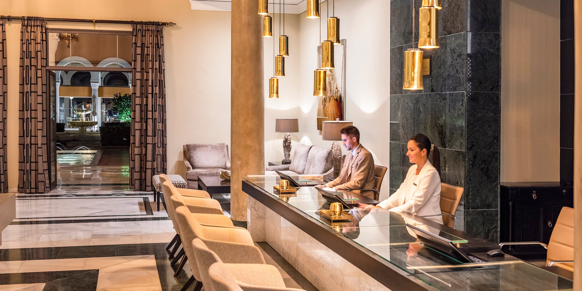 a group of people sitting at a counter in a hotel