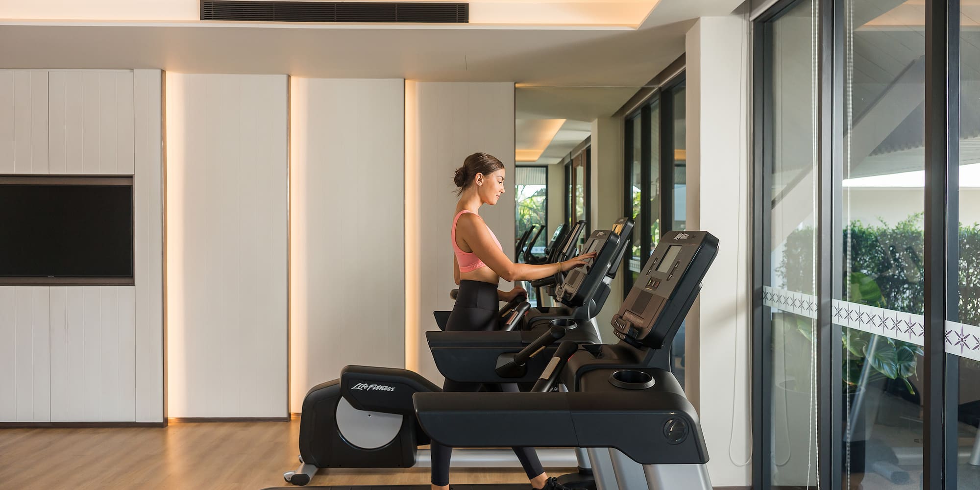 a woman on a treadmill in a gym