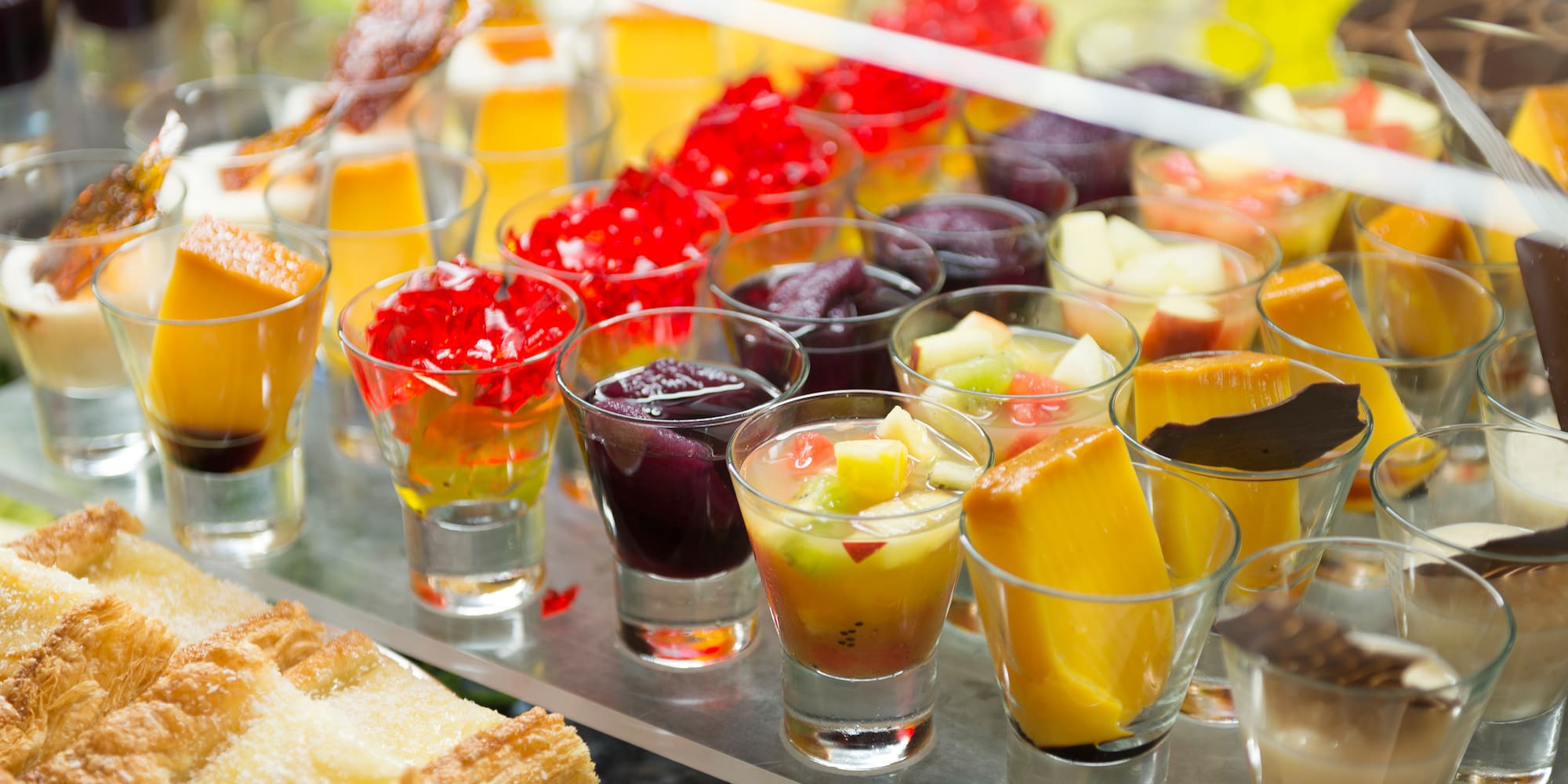 a group of glasses of fruit and jelly