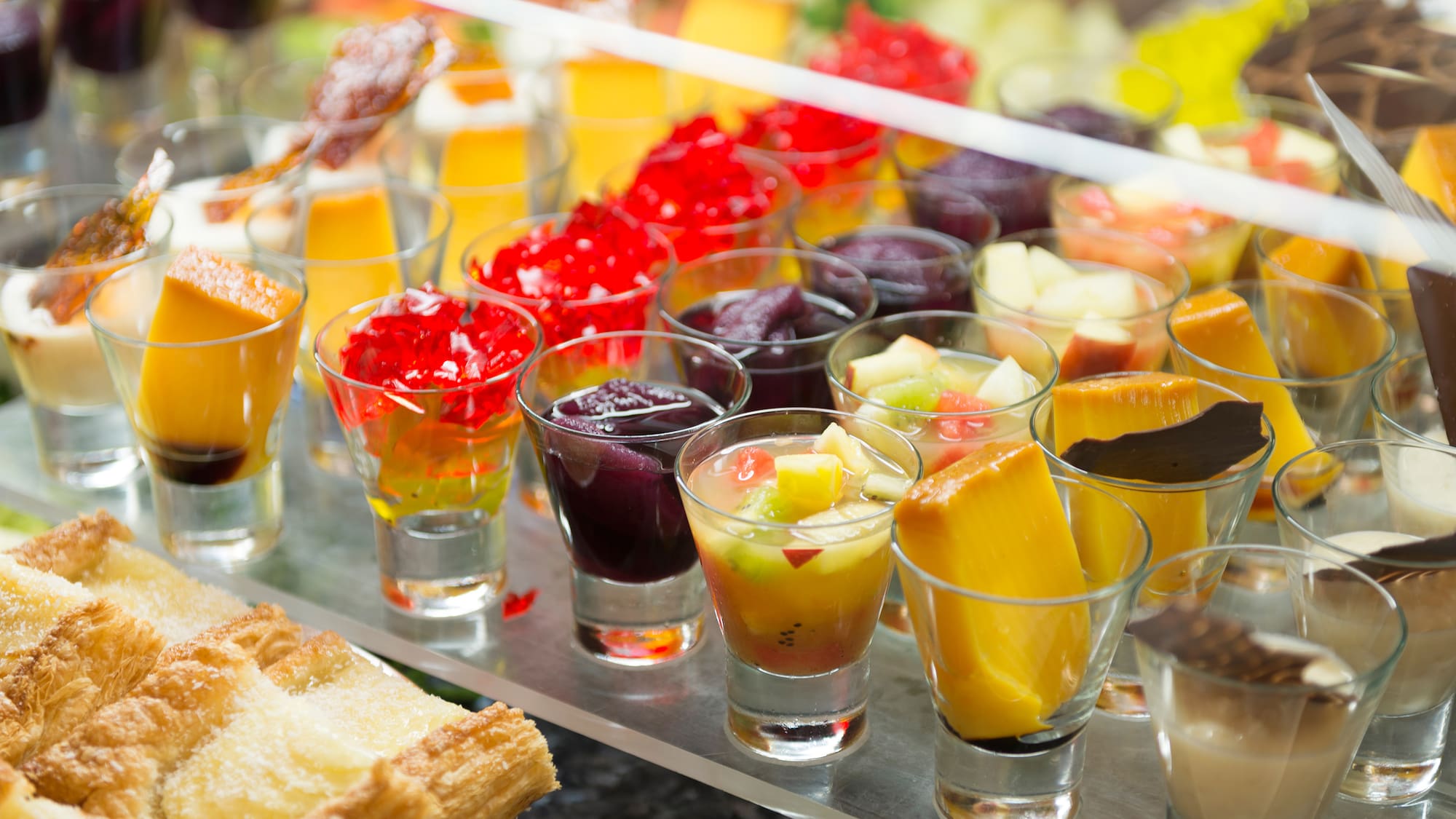 a group of glasses of fruit and jelly