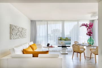 a living room with a table and chairs
