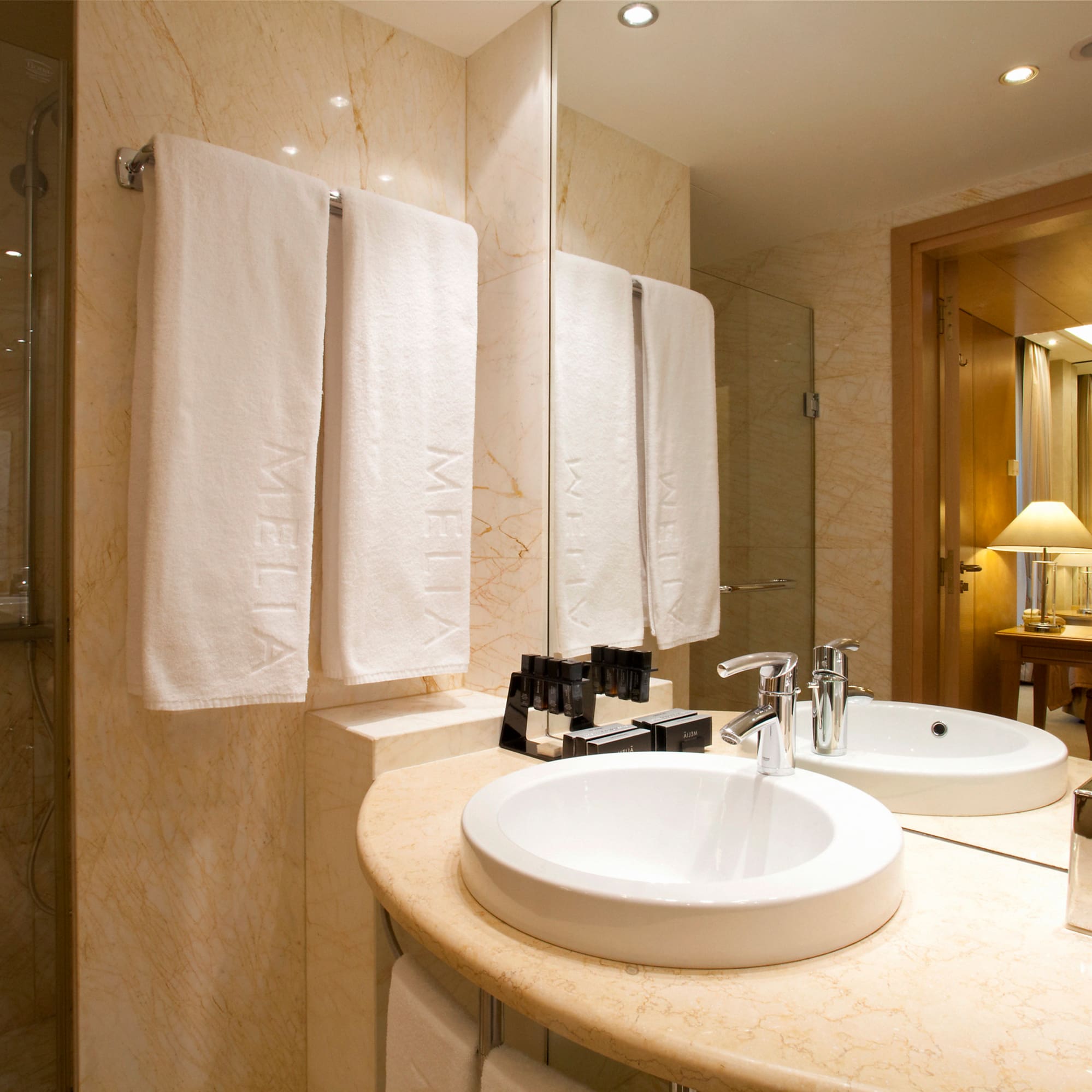 a bathroom with a marble countertop and two sinks