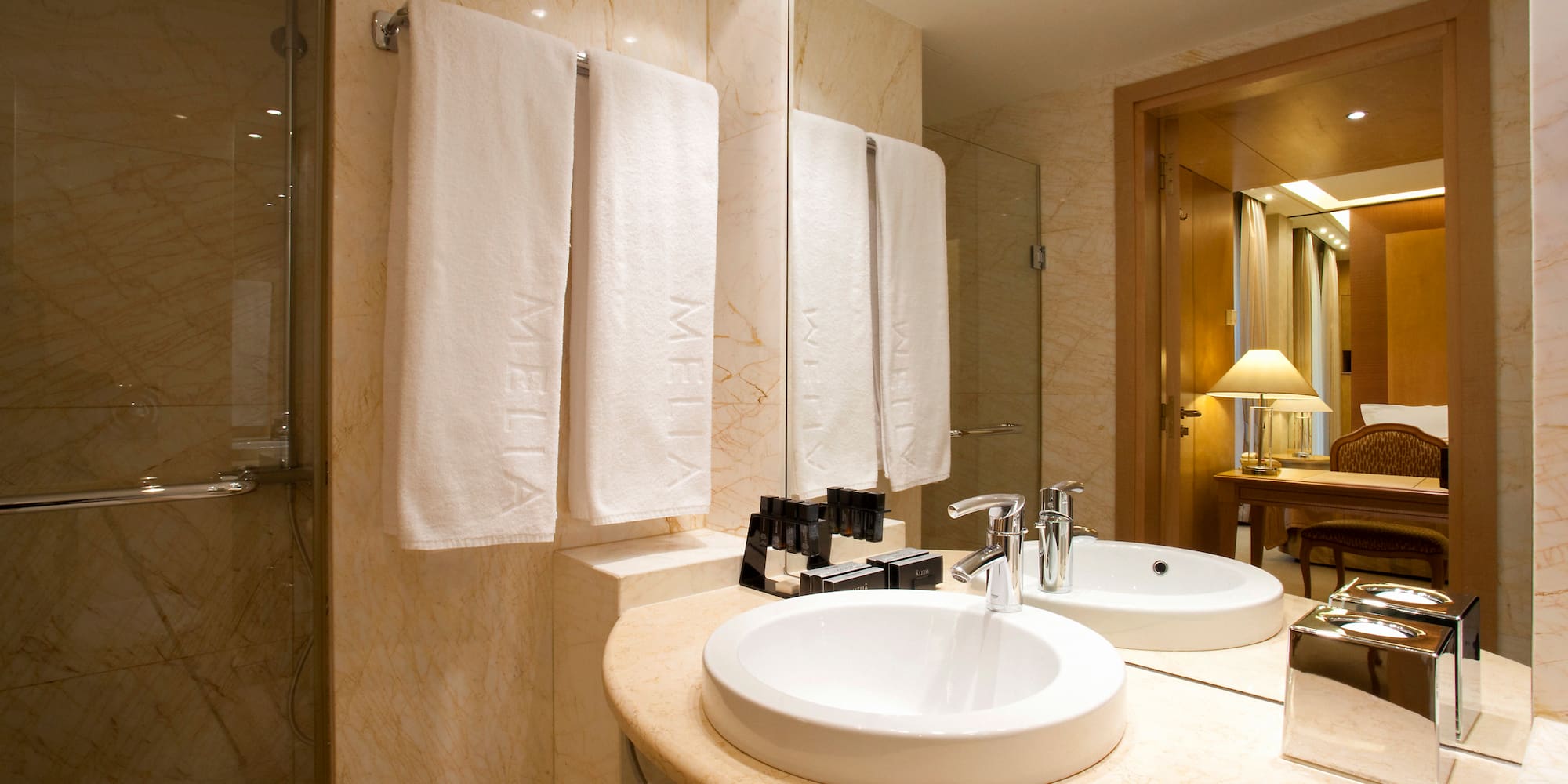 a bathroom with a marble countertop and two sinks