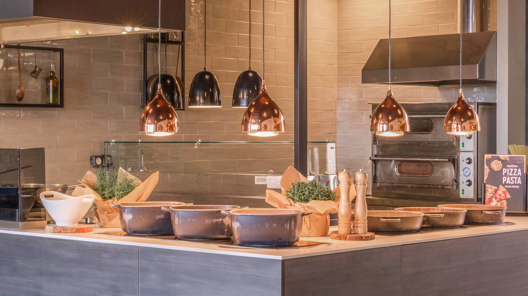 a kitchen with a large counter and many pots