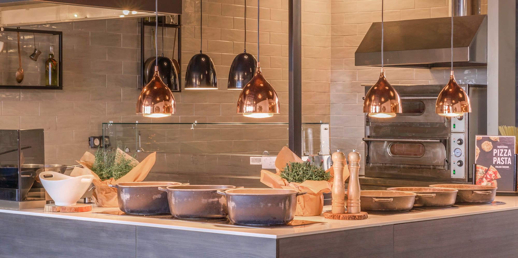 a kitchen with a large counter and many pots