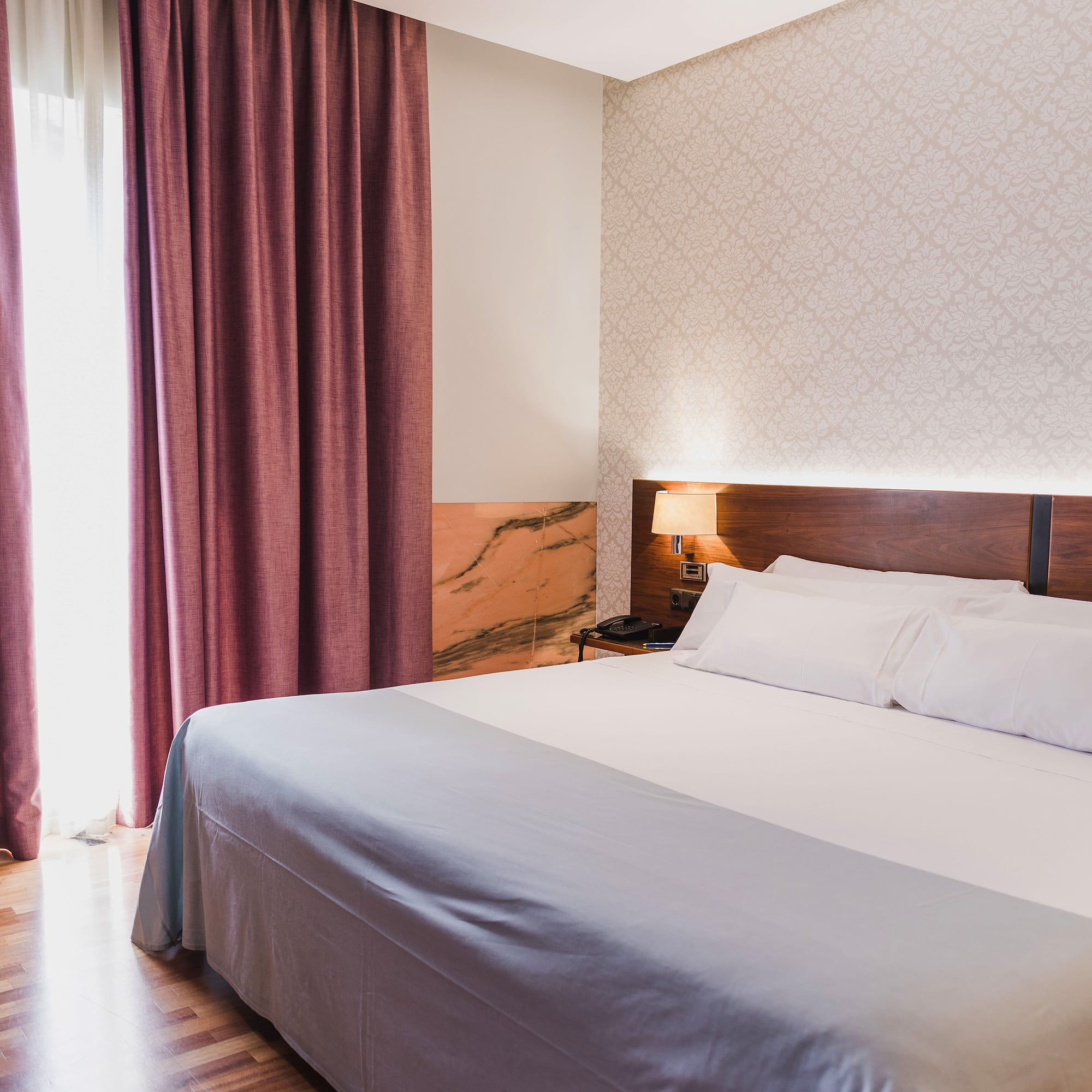 a bed with a lamp and a window