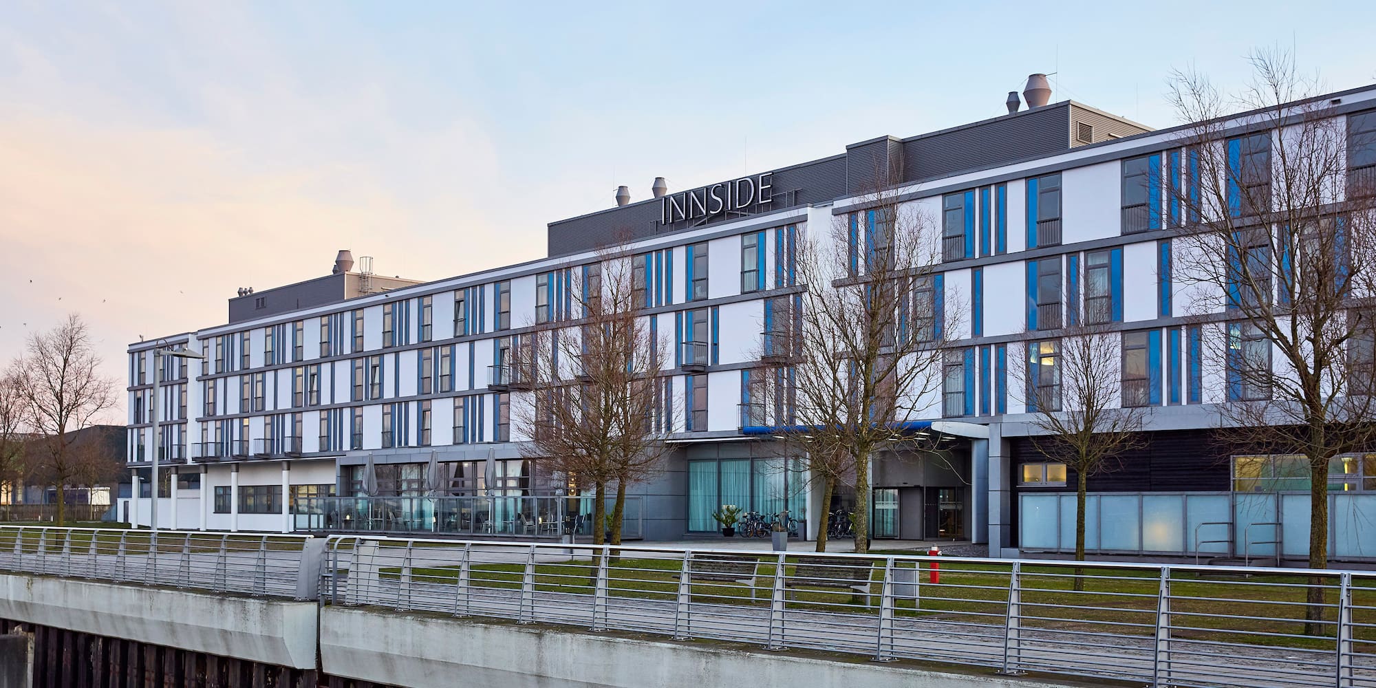 a building with a bridge and trees