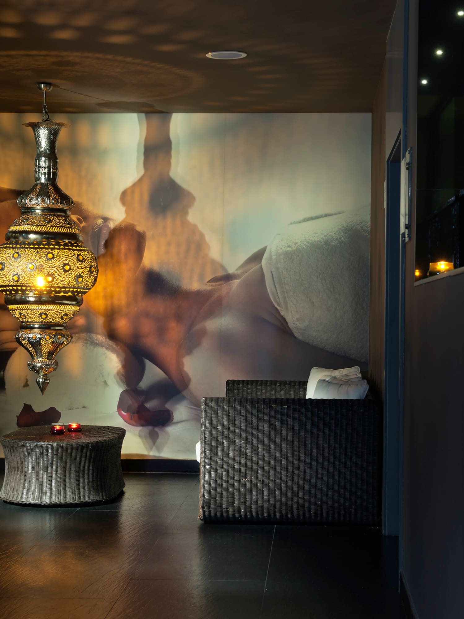 a room with a lamp and a wall mural