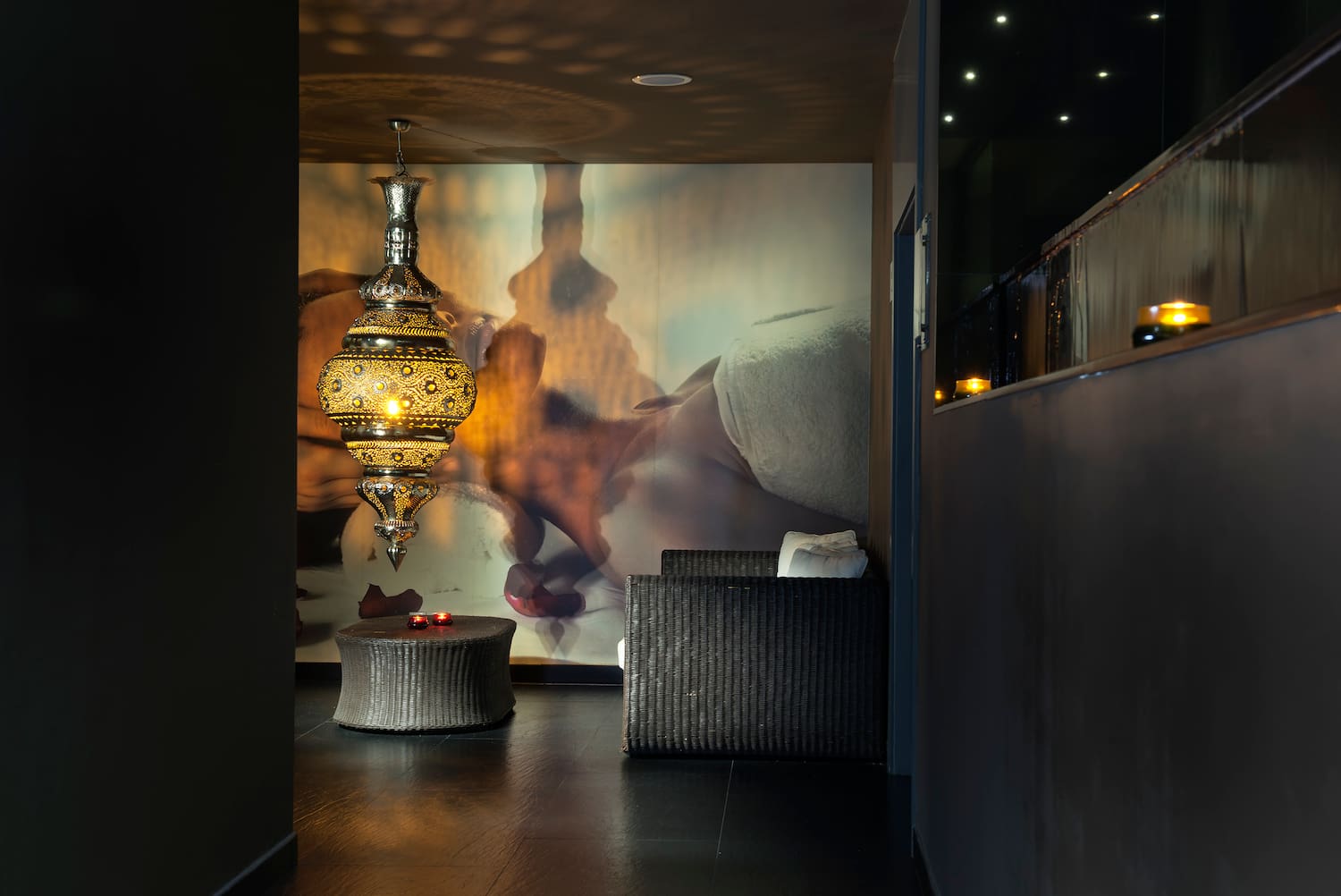 a room with a lamp and a wall mural