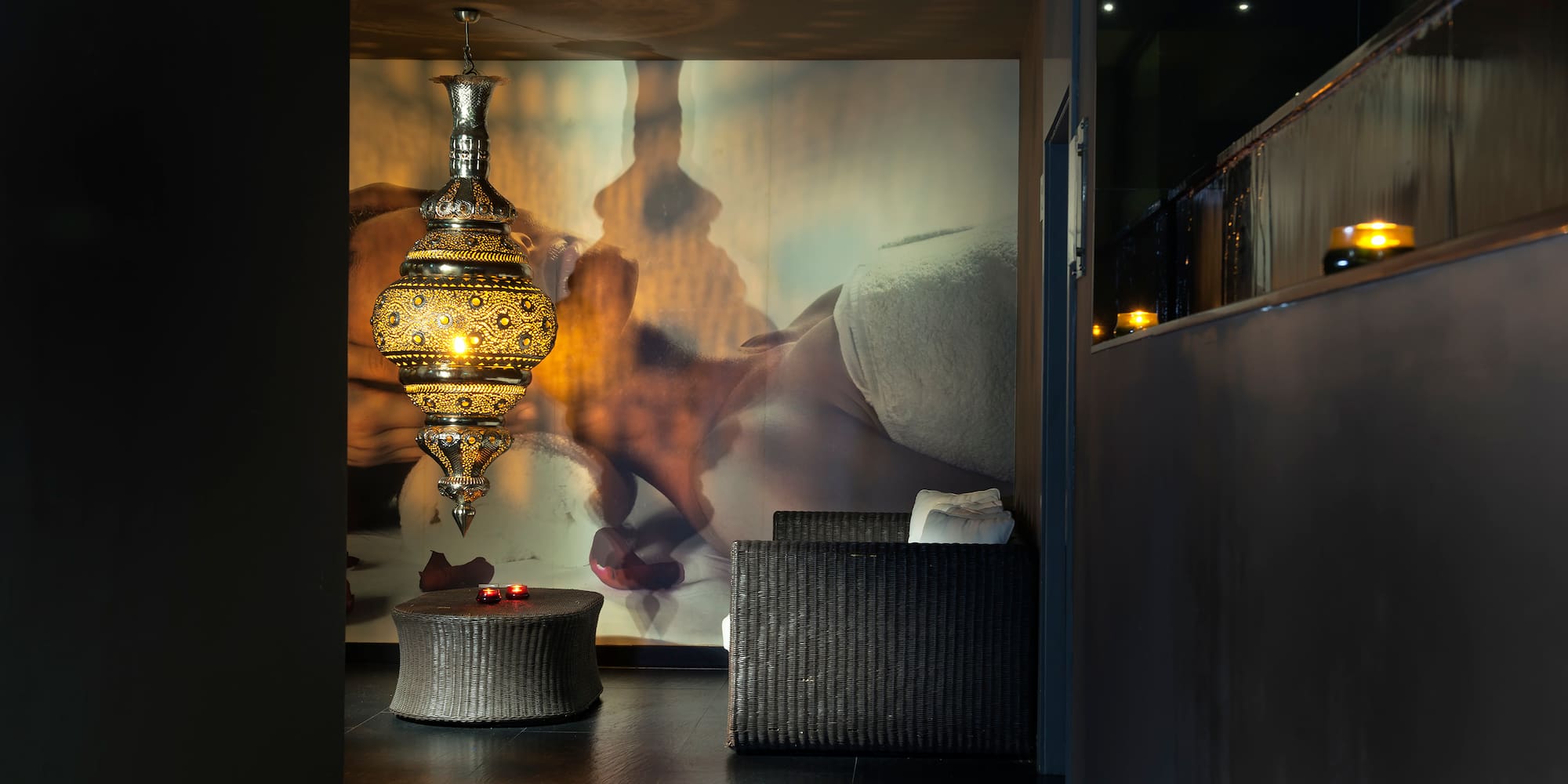 a room with a lamp and a wall mural