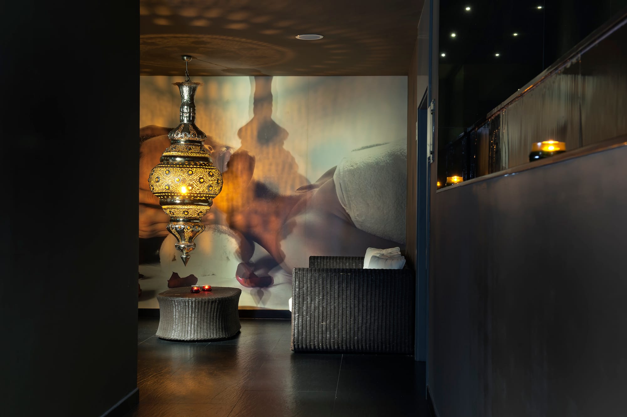 a room with a lamp and a wall mural