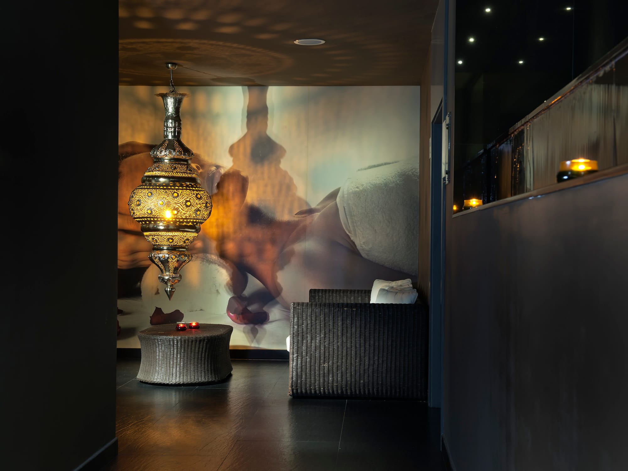 a room with a lamp and a wall mural