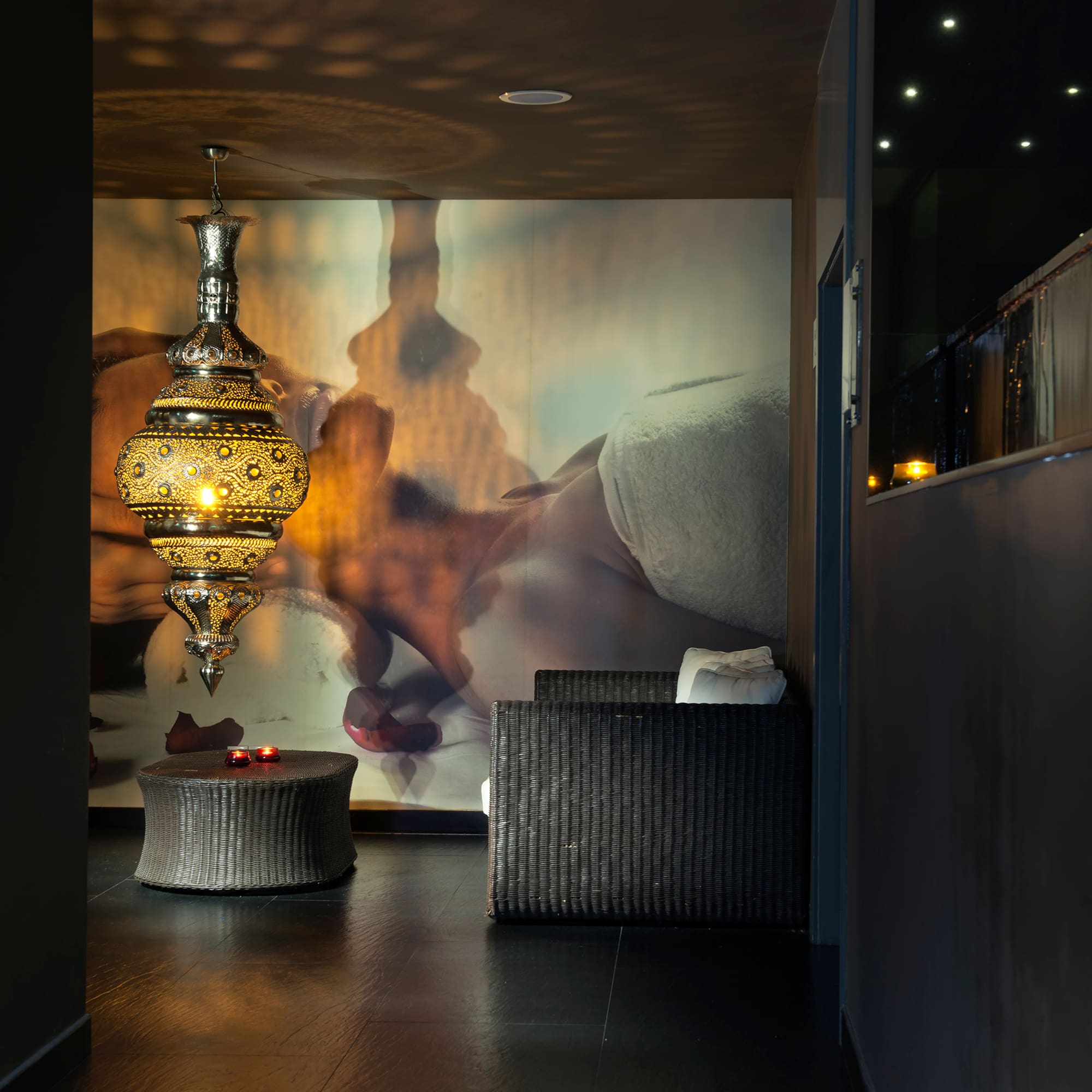 a room with a lamp and a wall mural