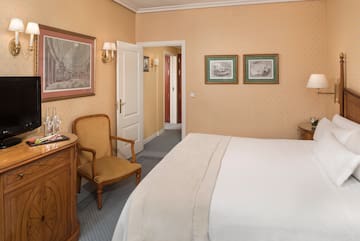 a bedroom with a bed and a chair