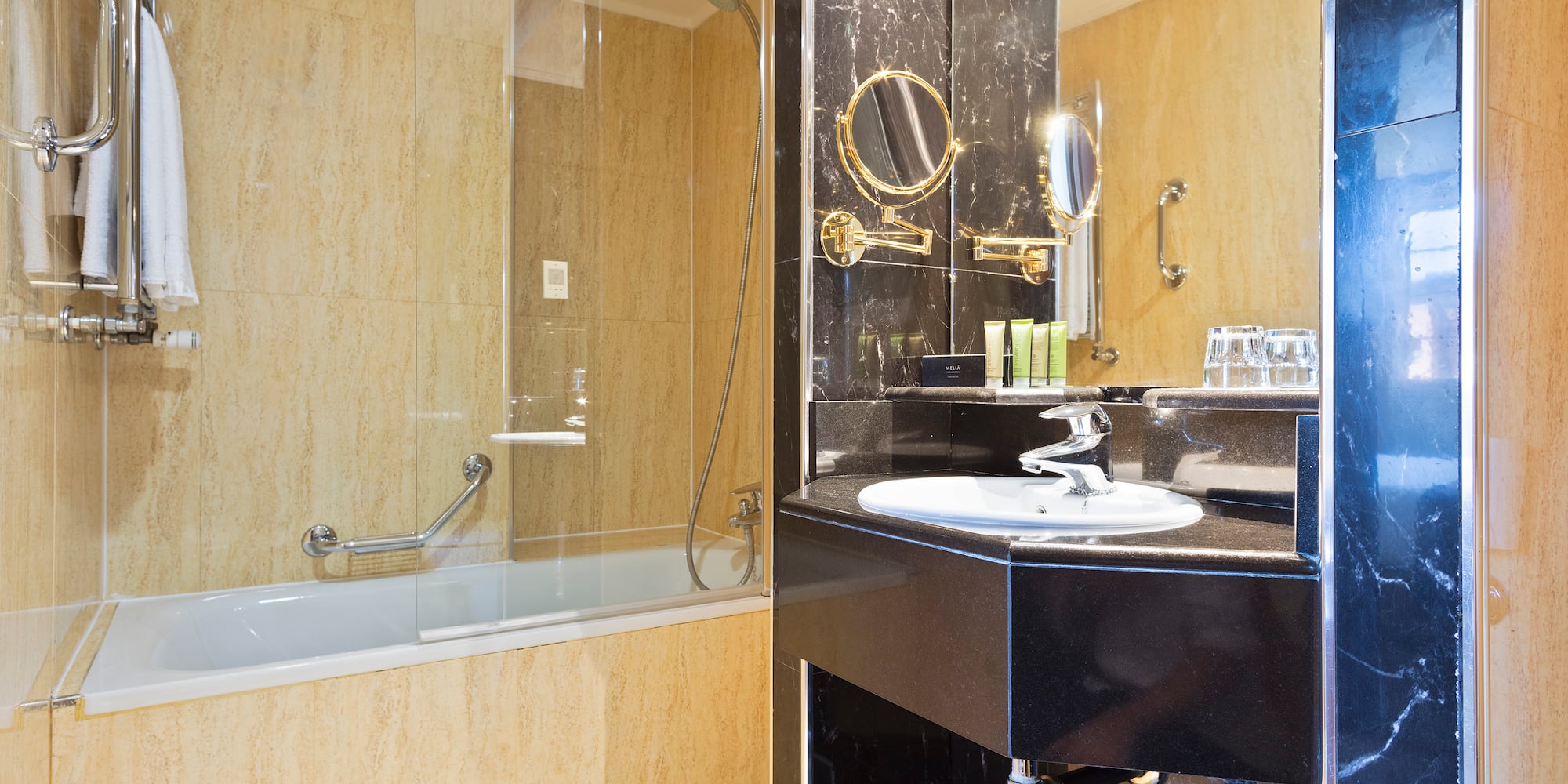 a bathroom with a glass shower and a sink