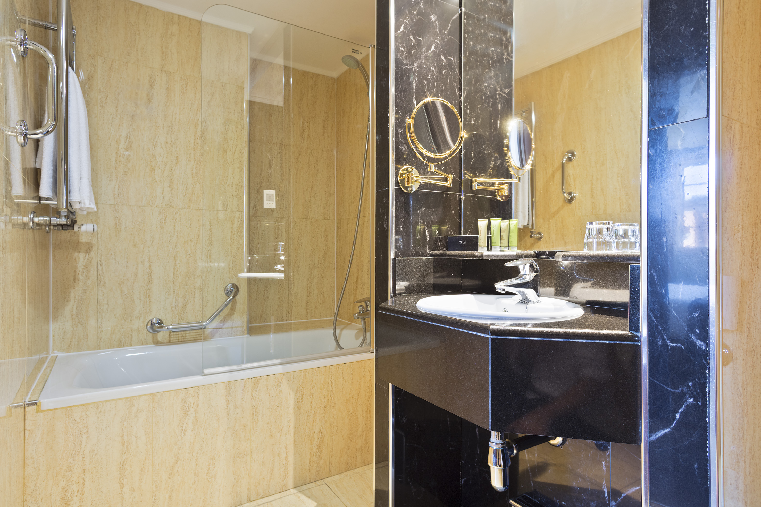 a bathroom with a glass shower and a sink