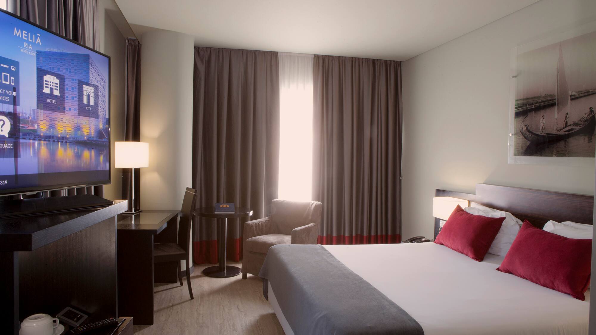 a room with a bed and a television