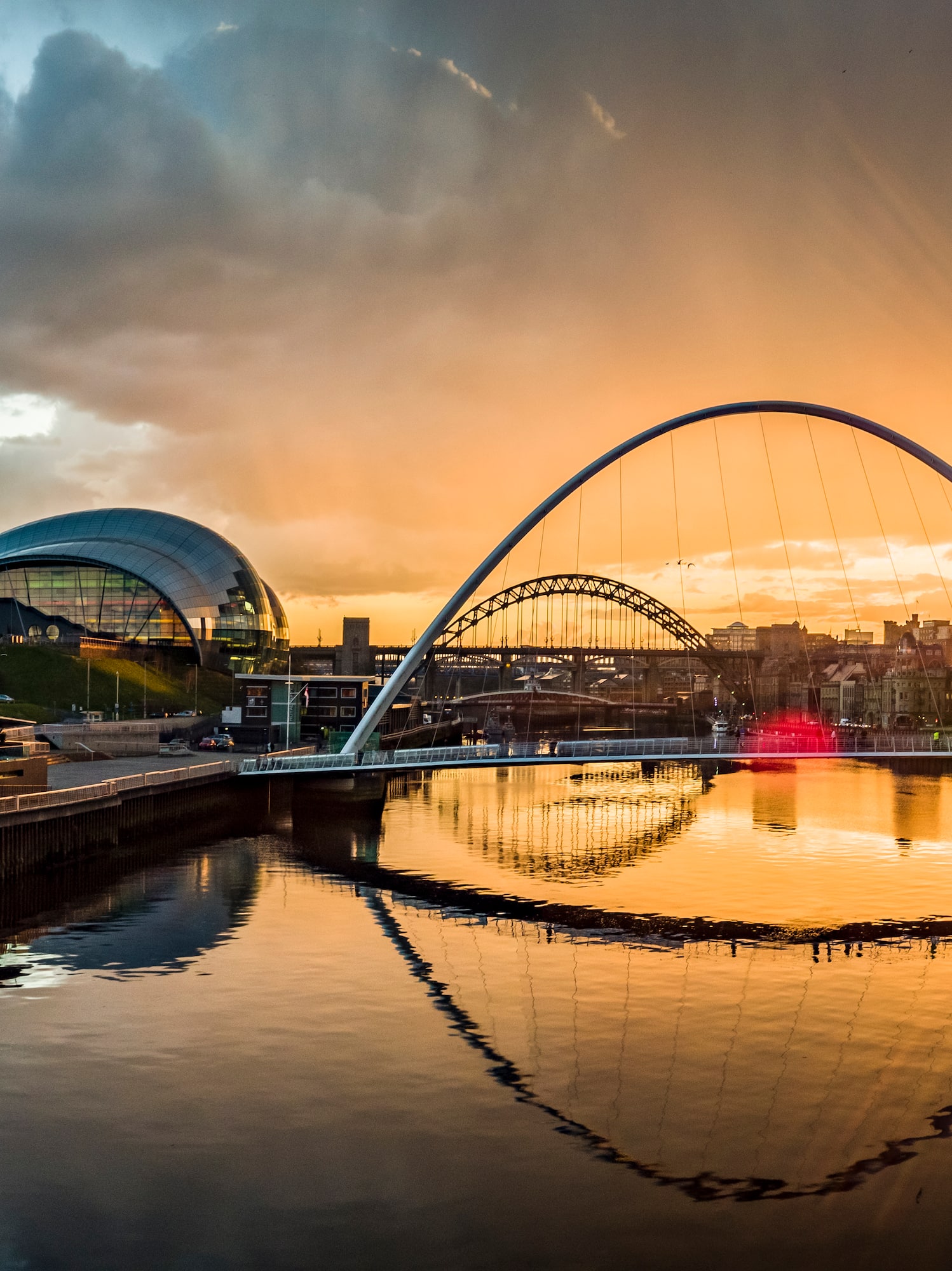 Golden sunset over River Tyne: Baltic Centre, Millennium Bridge, Sage Gateshead.