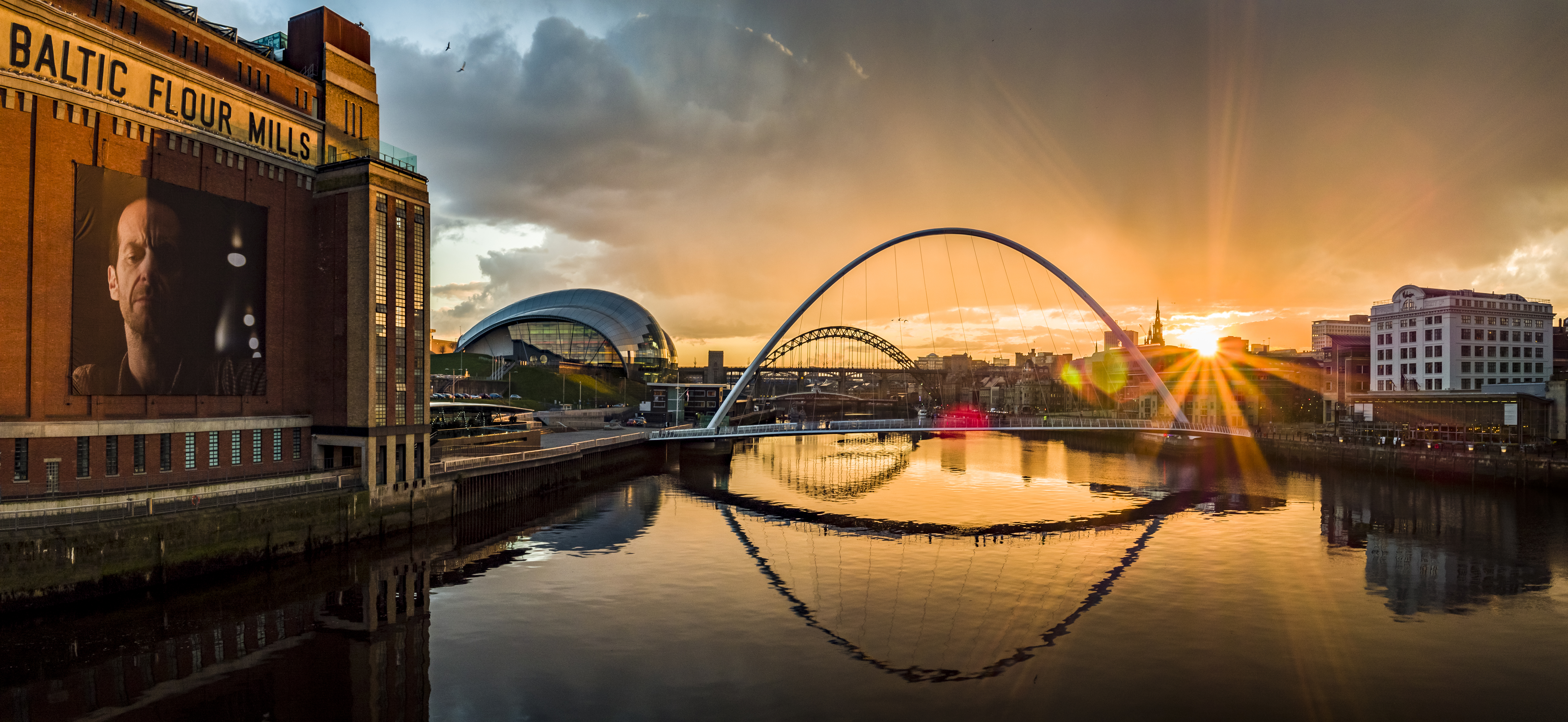Golden sunset over River Tyne: Baltic Centre, Millennium Bridge, Sage Gateshead.