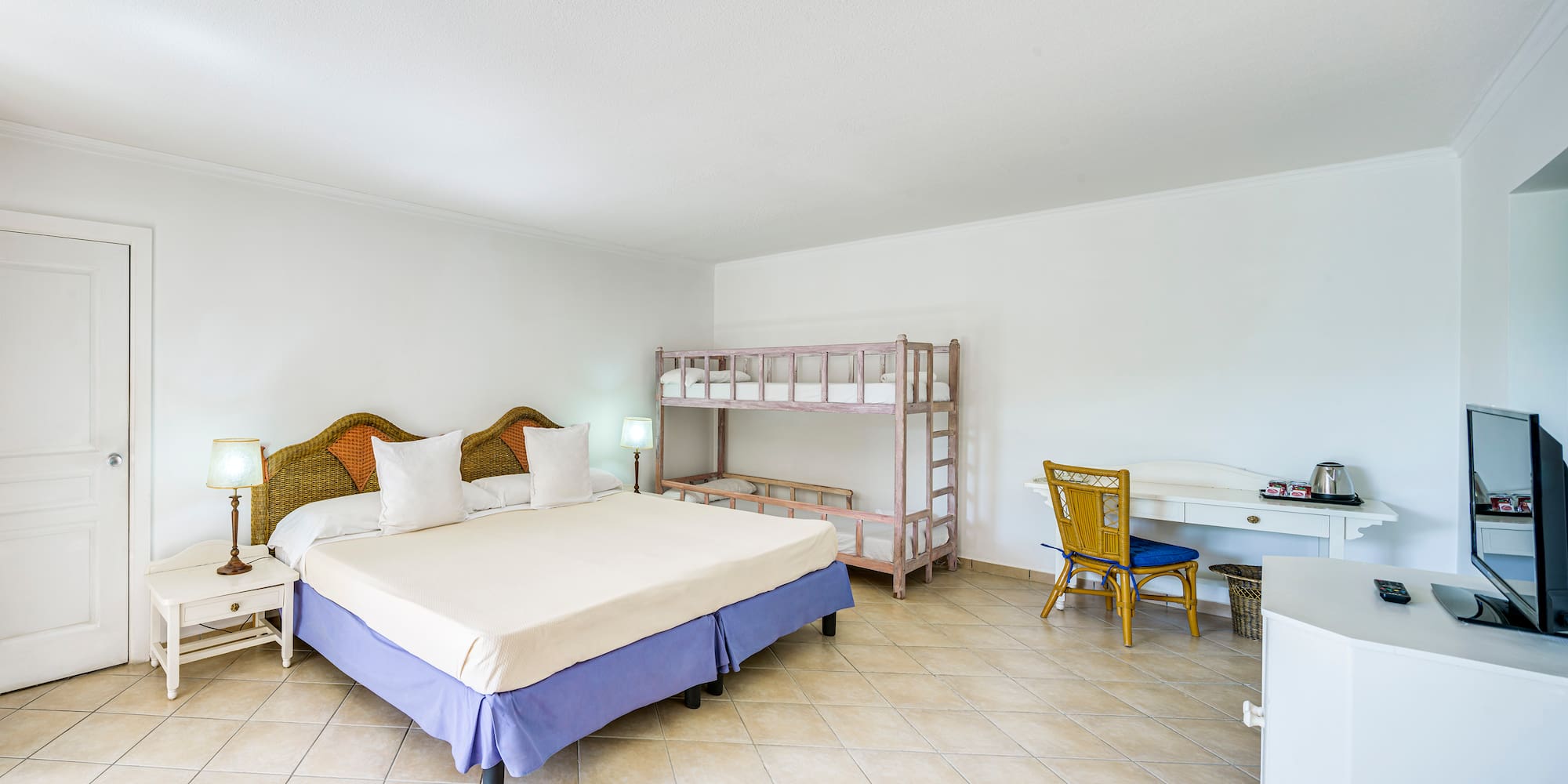 a room with a bed and bunk beds