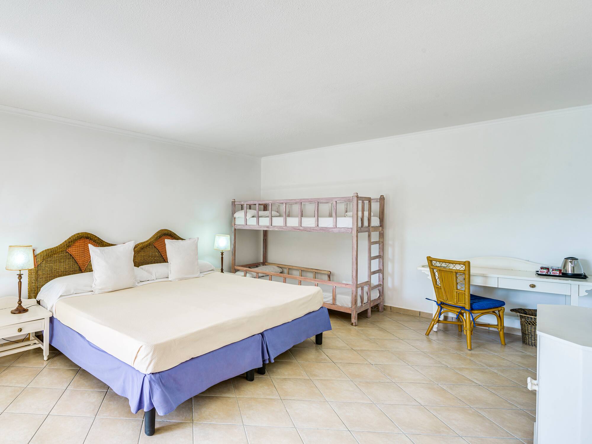 a room with a bed and bunk beds