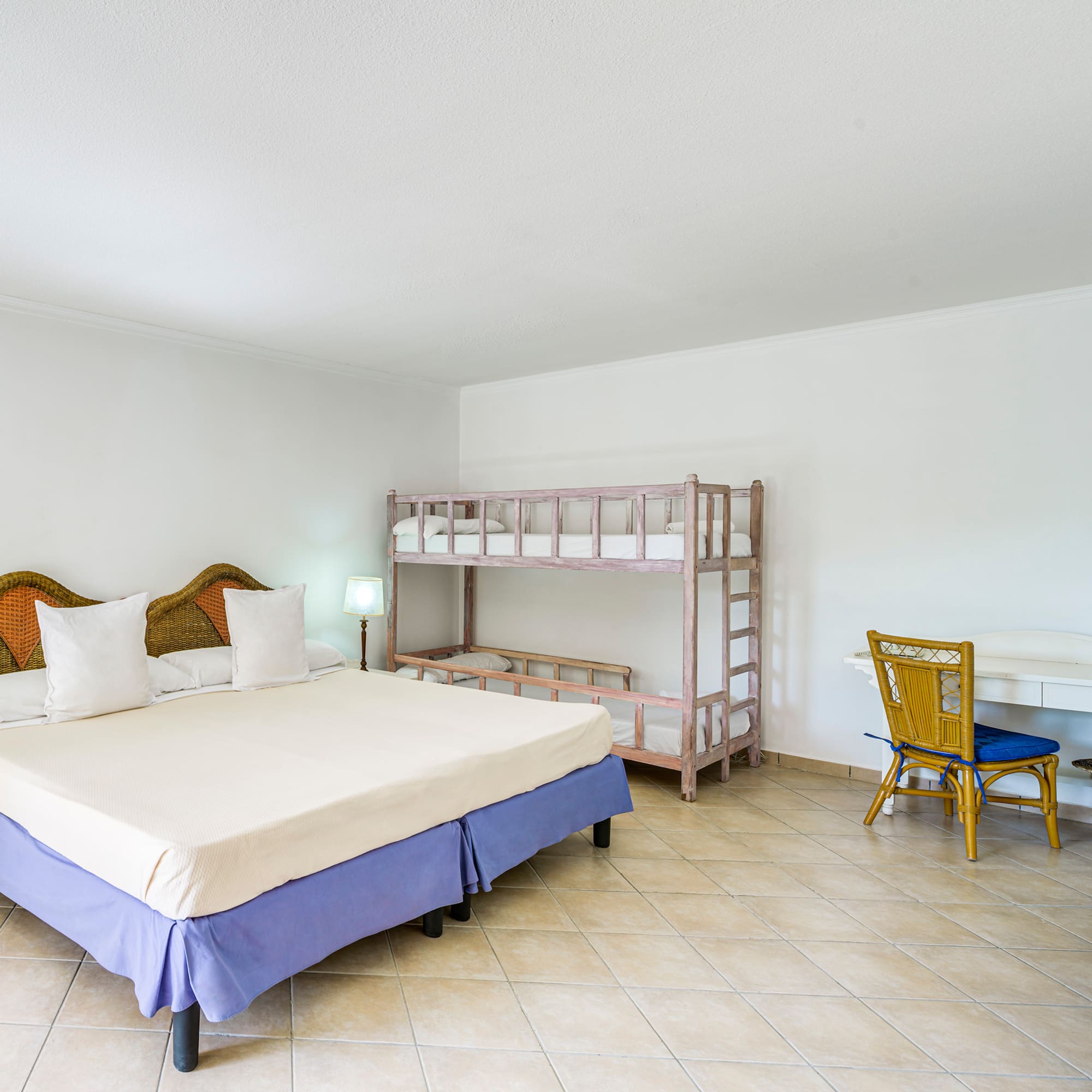 a room with a bed and bunk beds