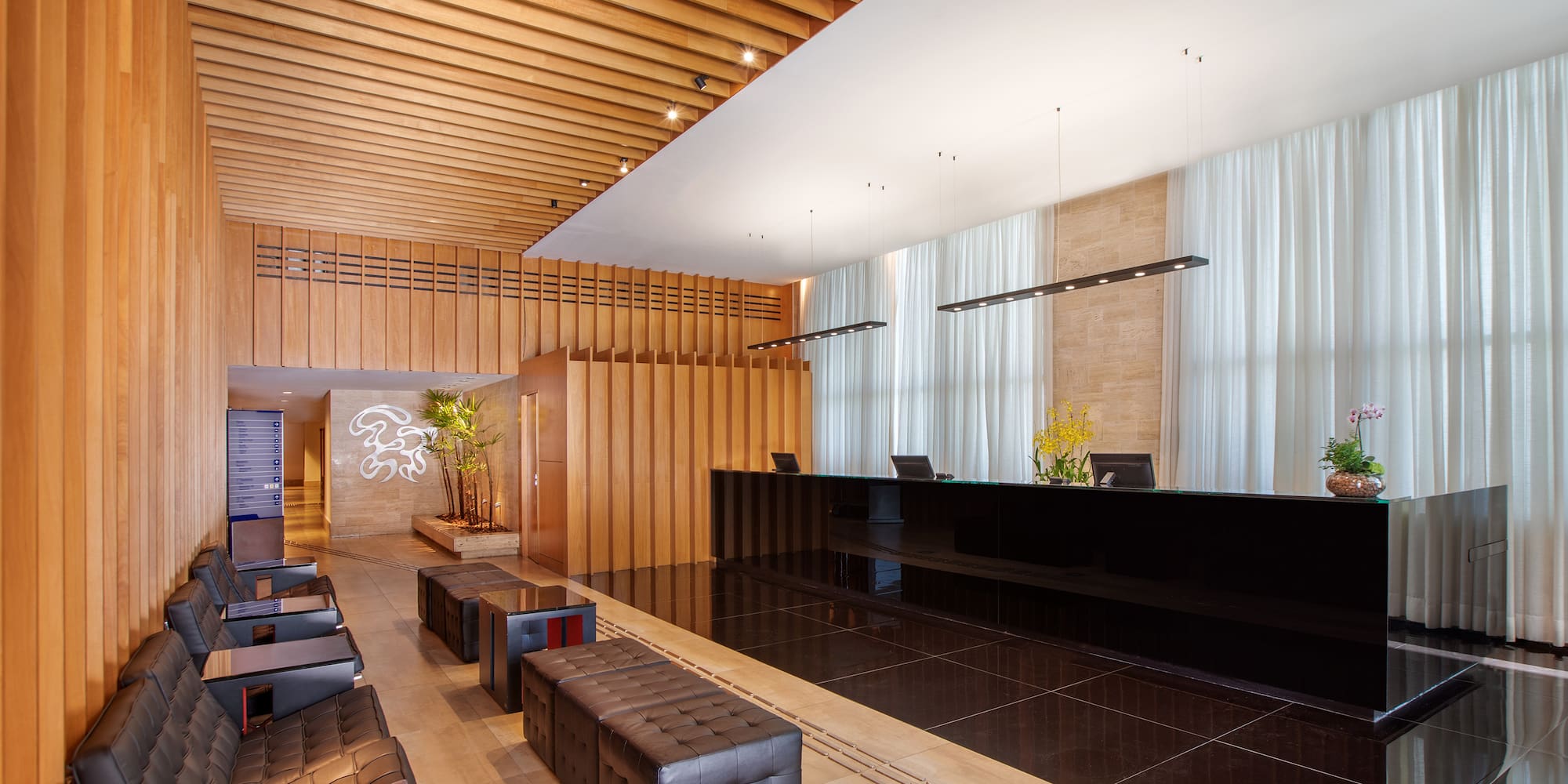 a lobby with a black counter and chairs