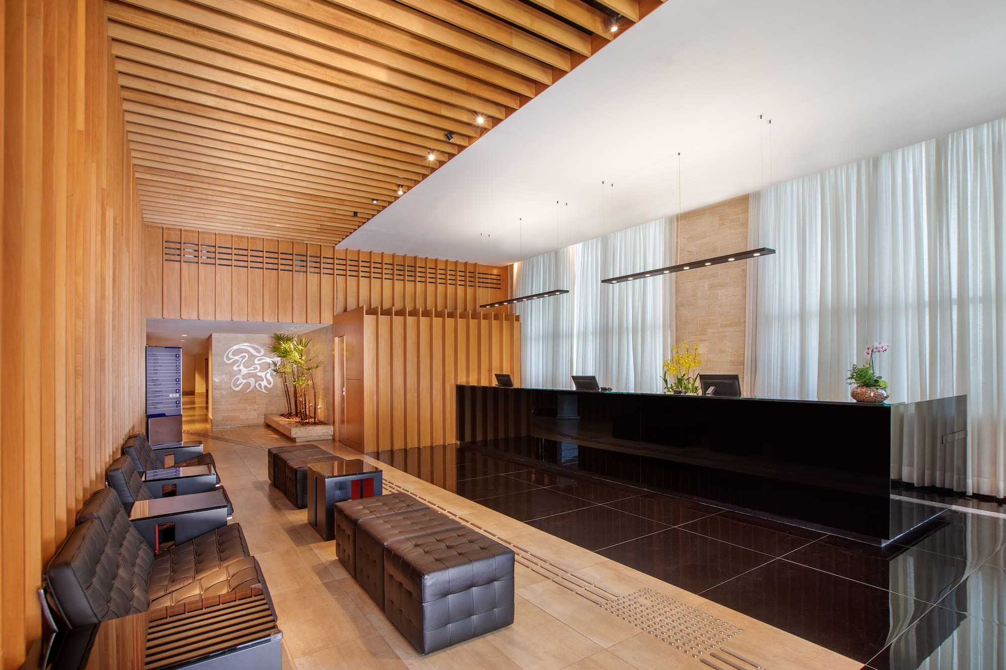 a lobby with a black counter and chairs
