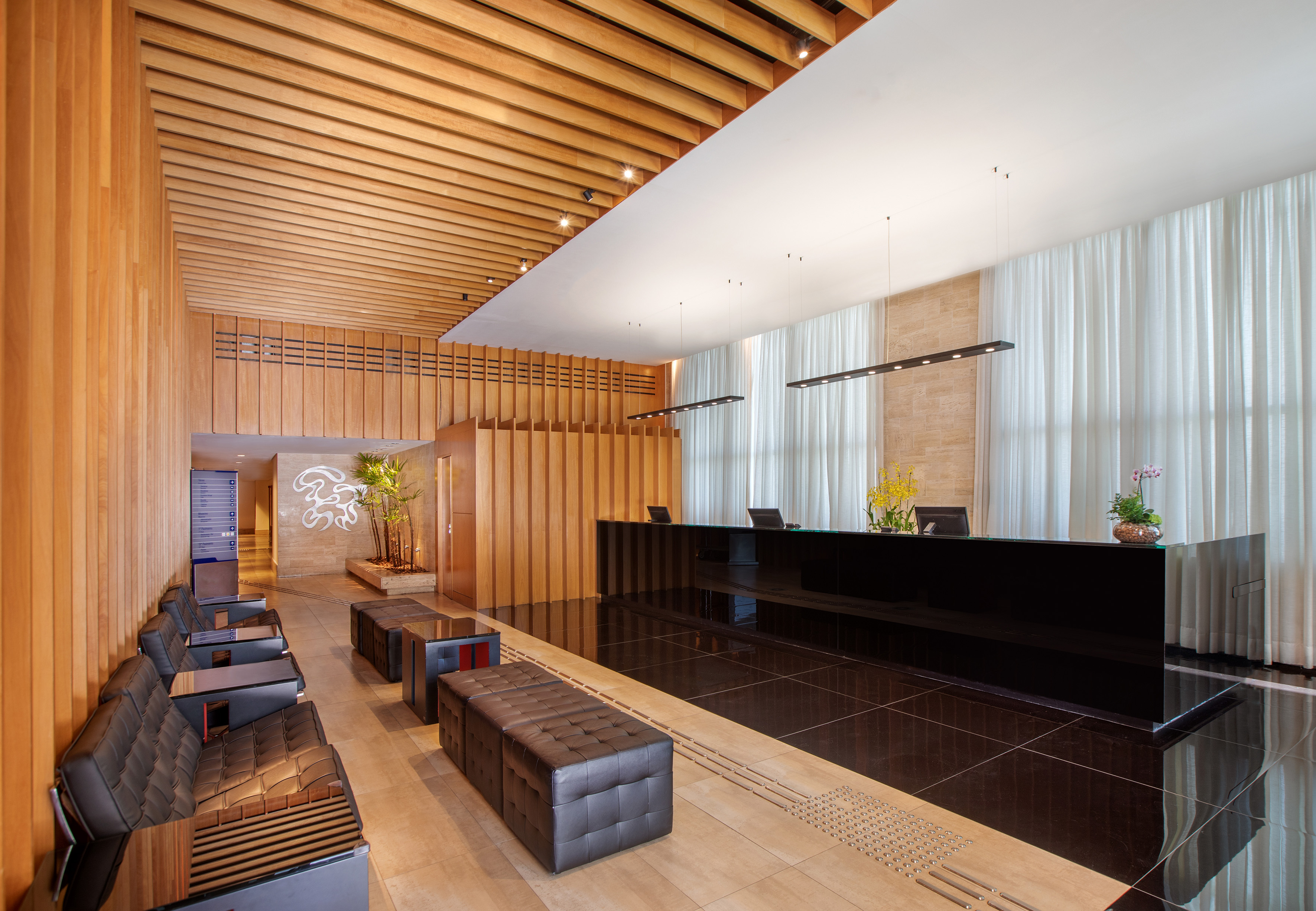 a lobby with a black counter and chairs