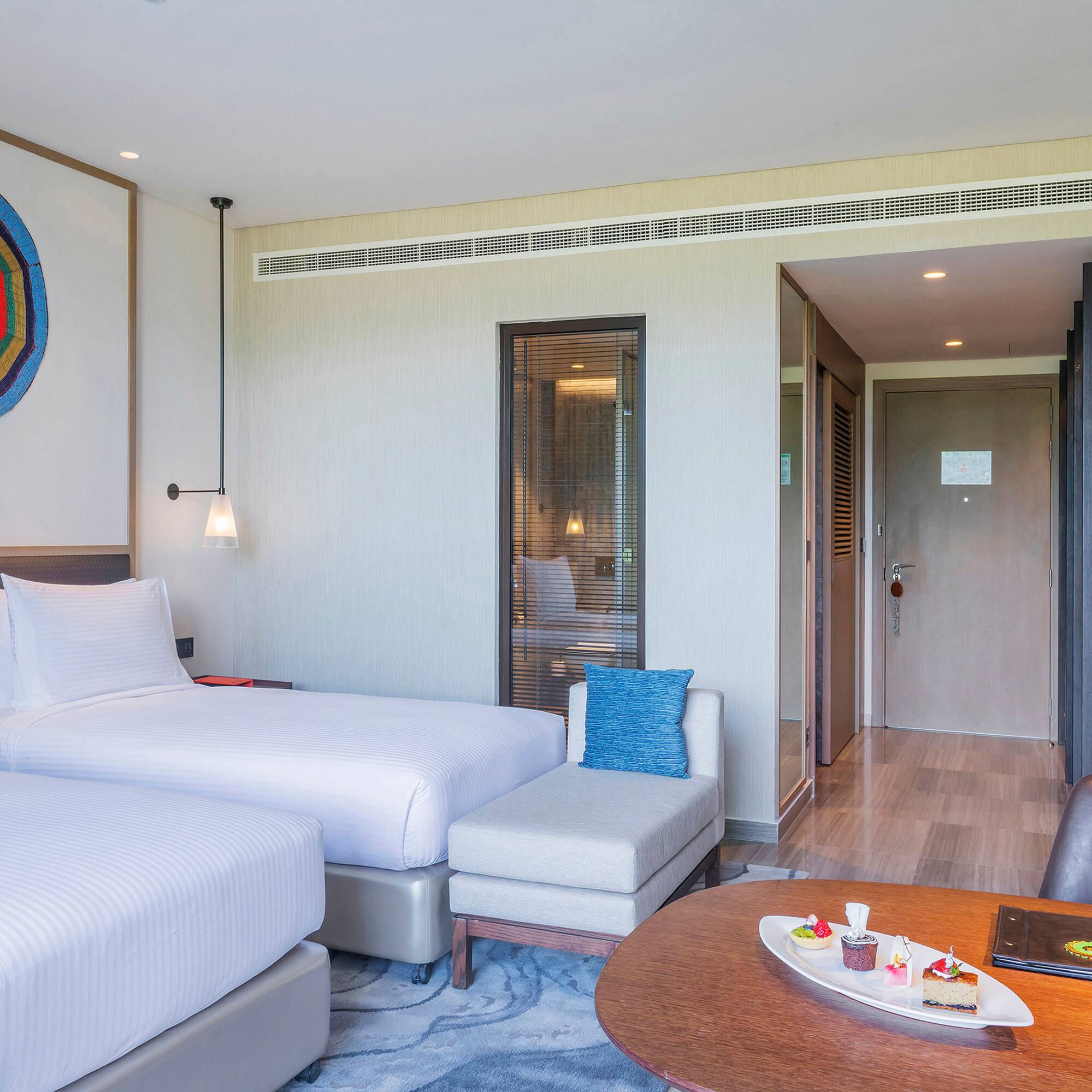 a room with two beds and a table