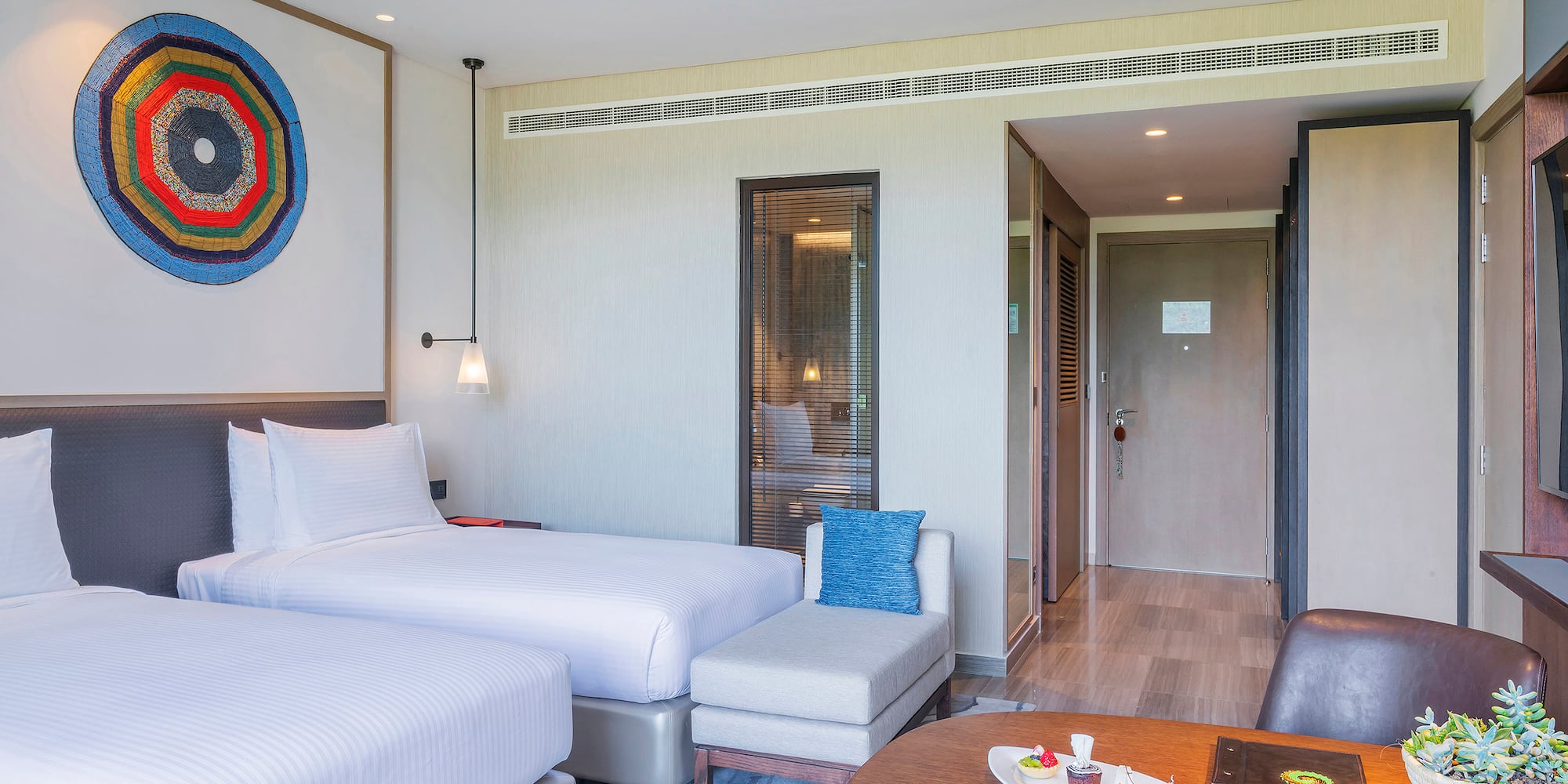 a room with two beds and a table