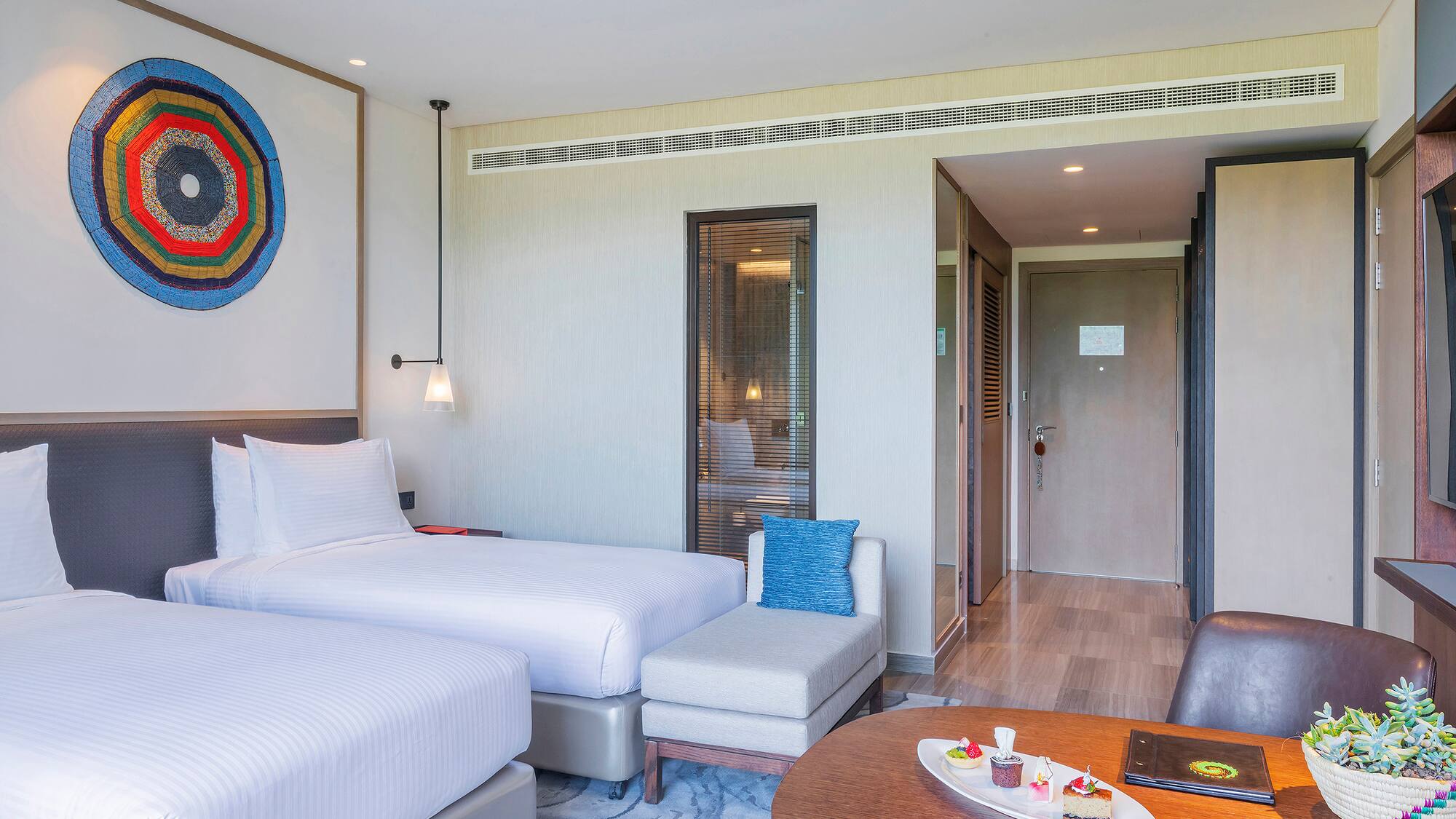 a room with two beds and a table