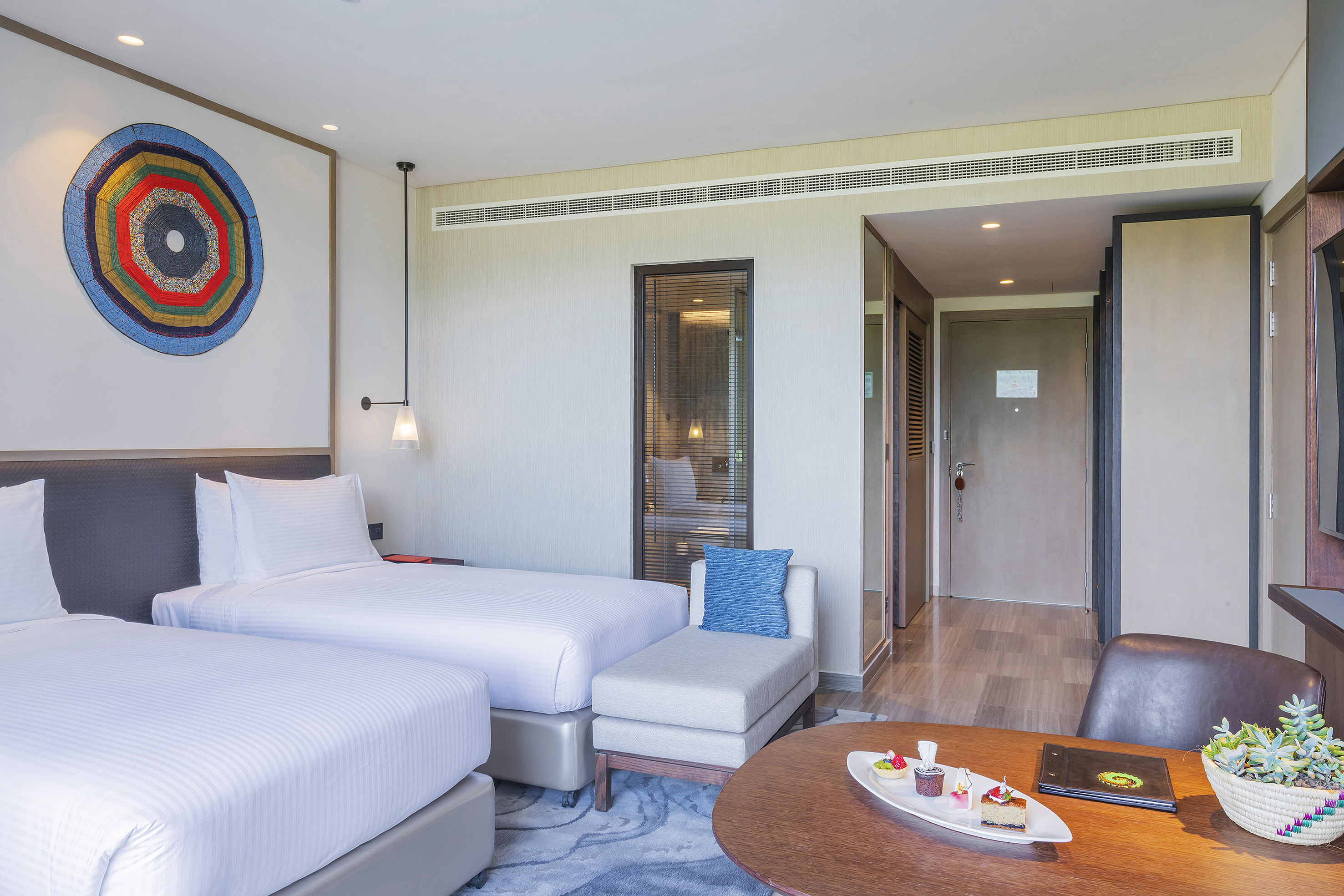 a room with two beds and a table