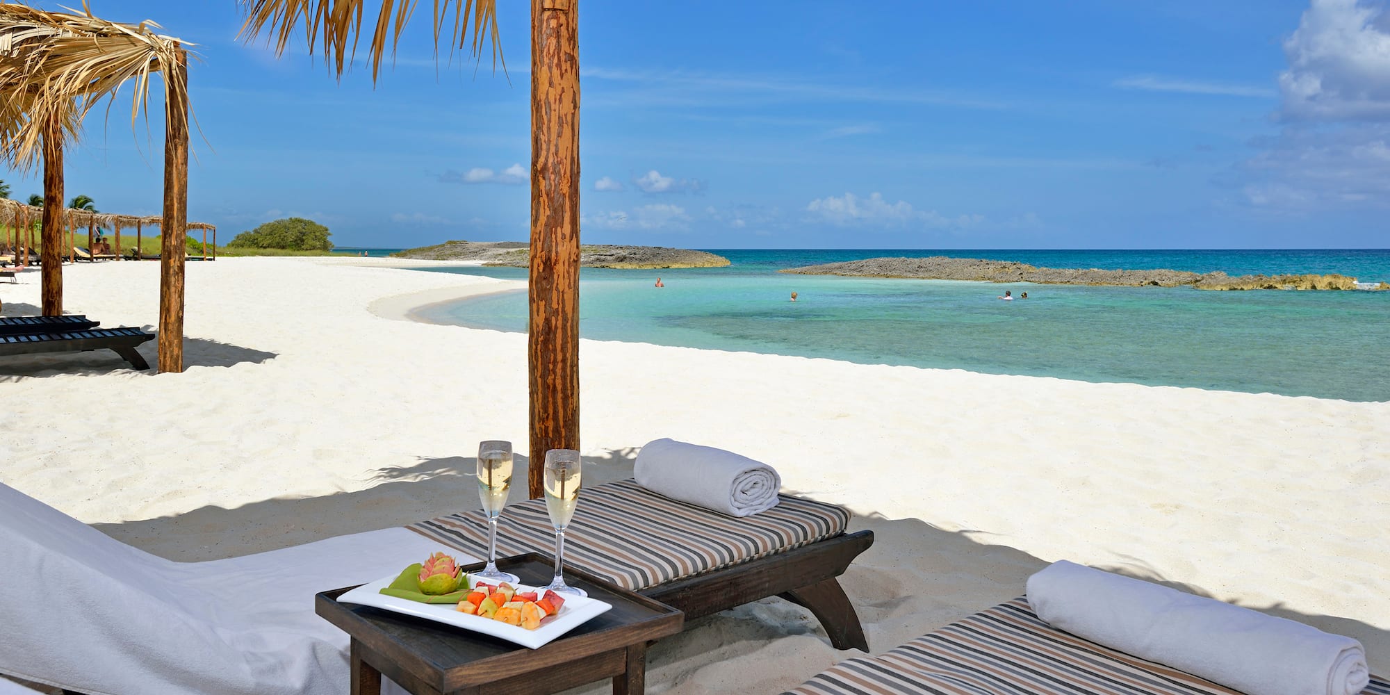a table with food on it on a beach