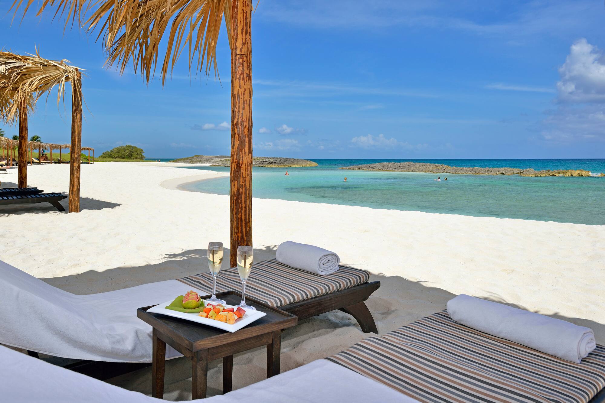a table with food on it on a beach
