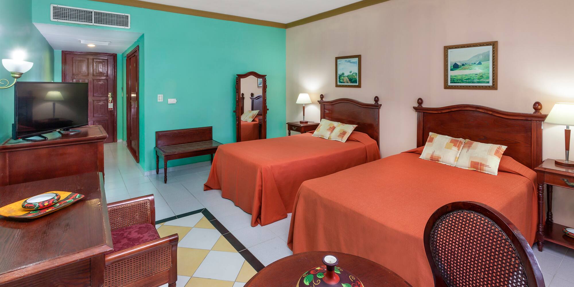 a room with two beds and a table