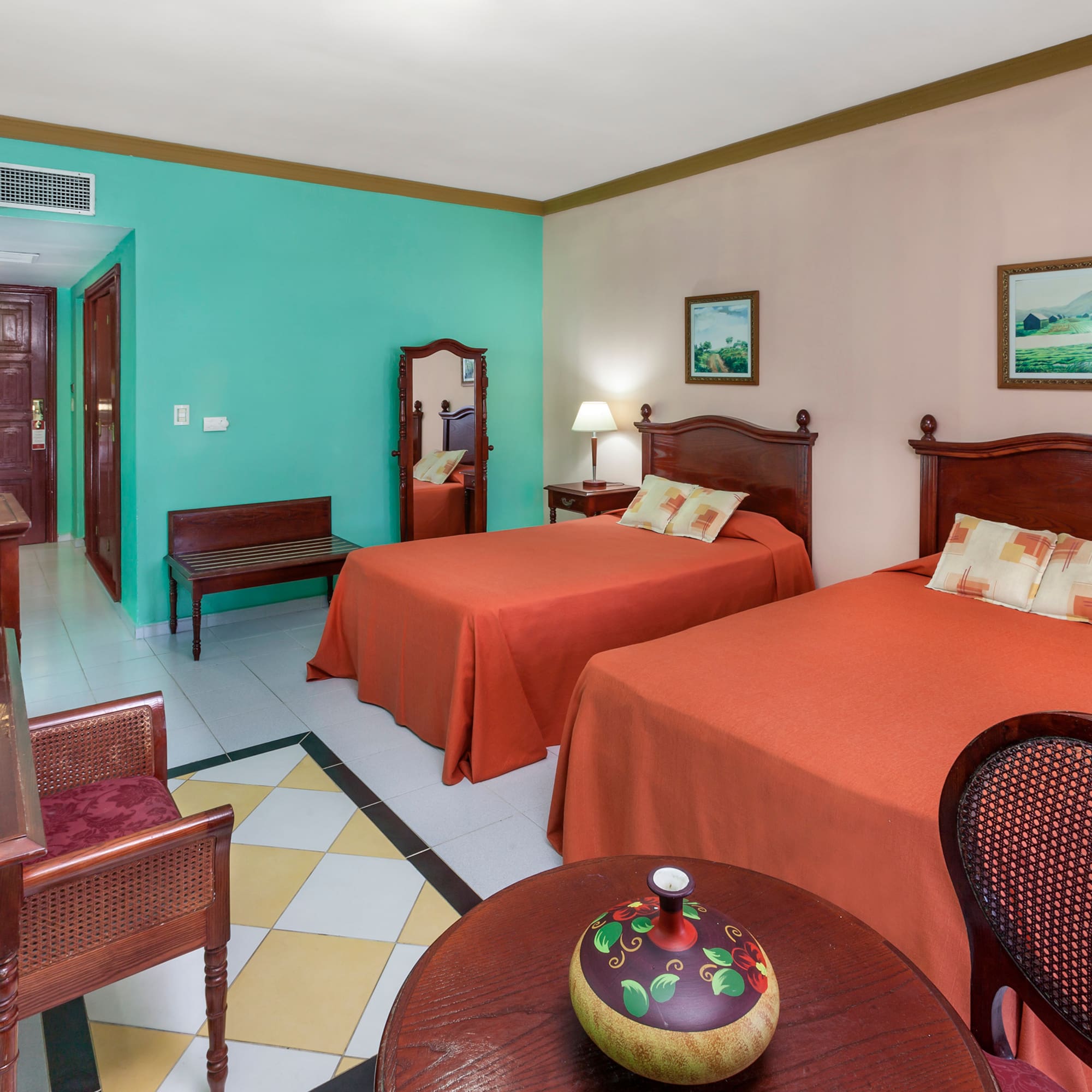 a room with two beds and a table