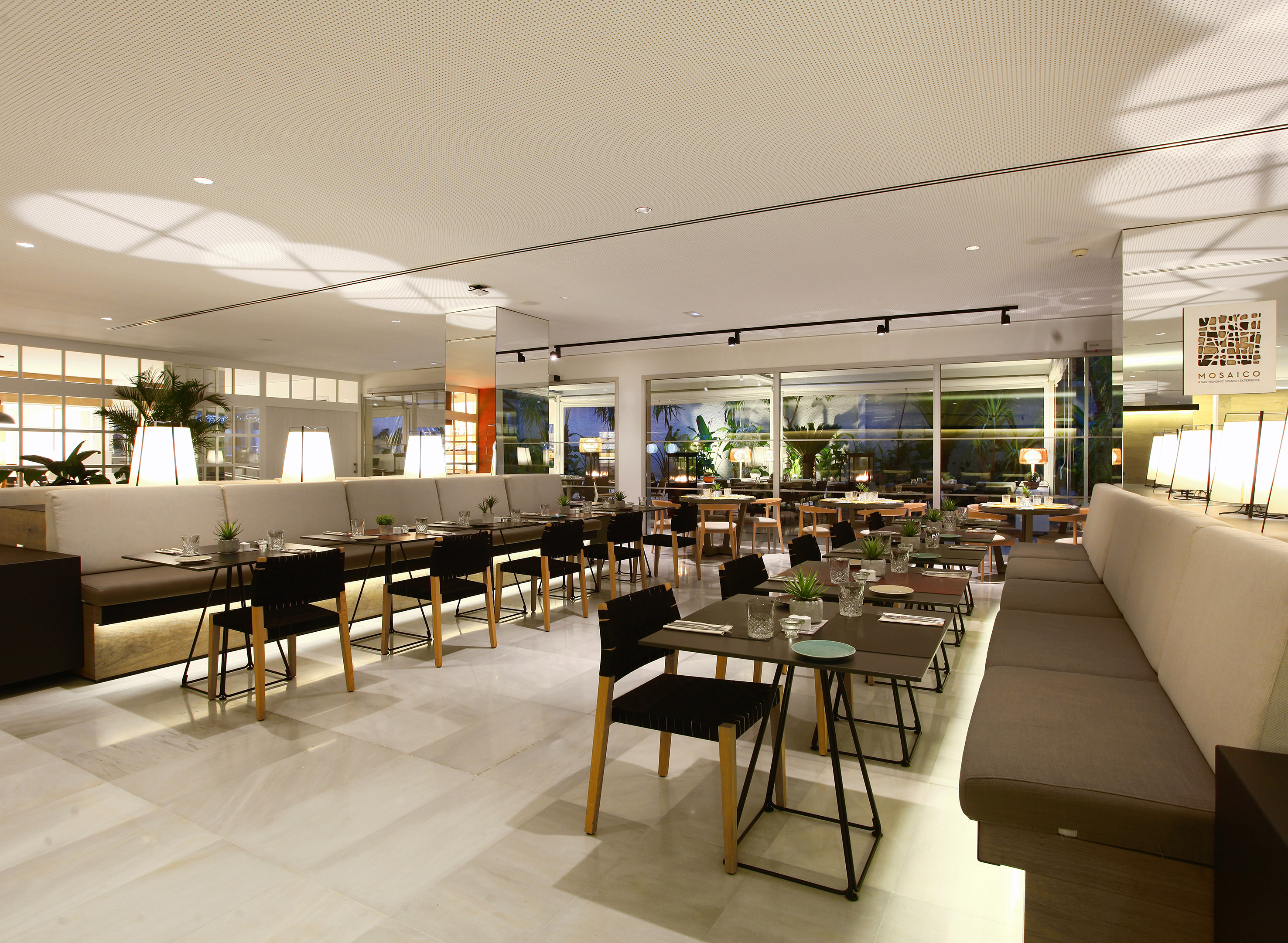 Elegant Mosaico restaurant dining room with modern tables and booths.