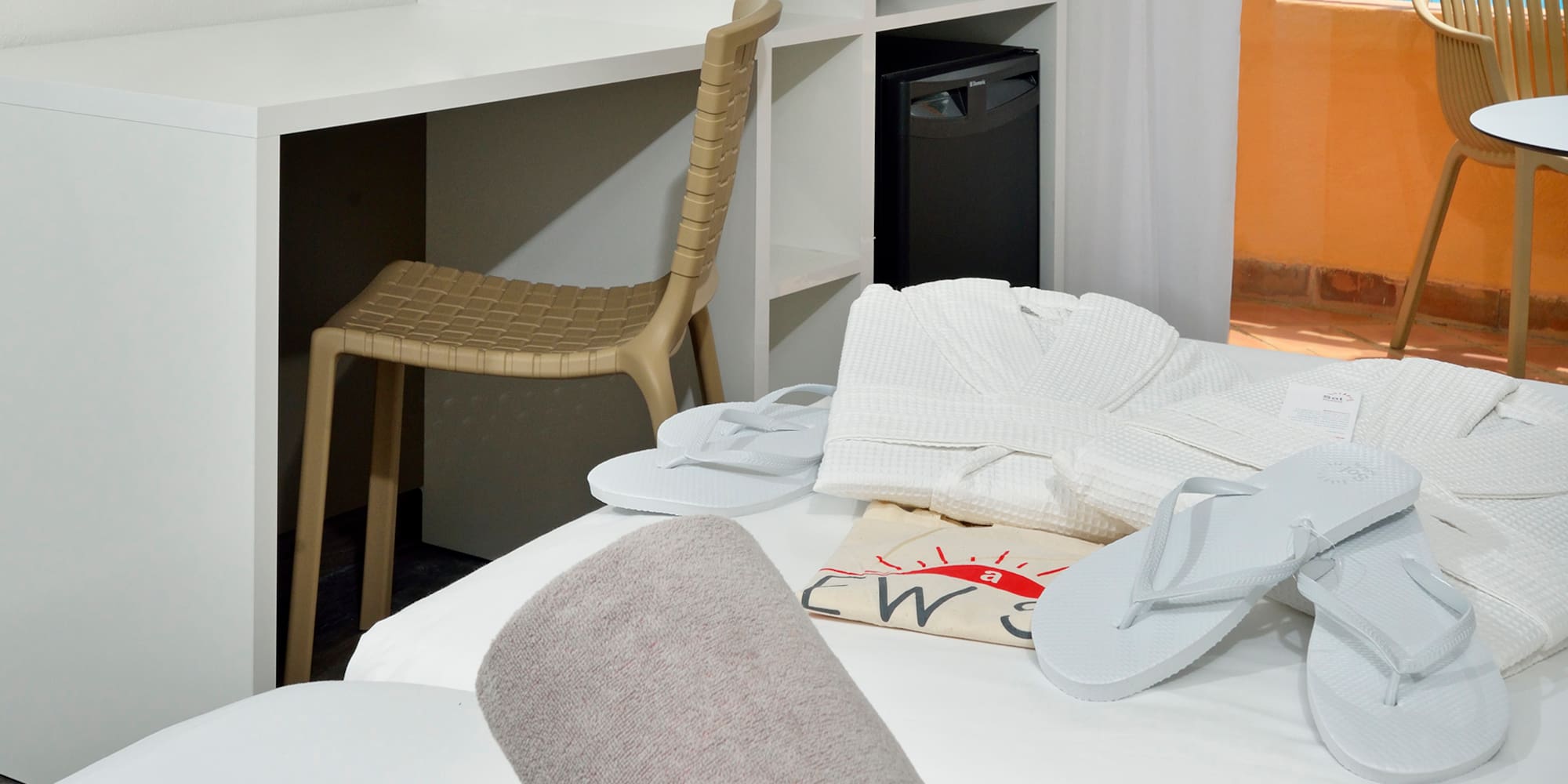 a room with a bed and towels