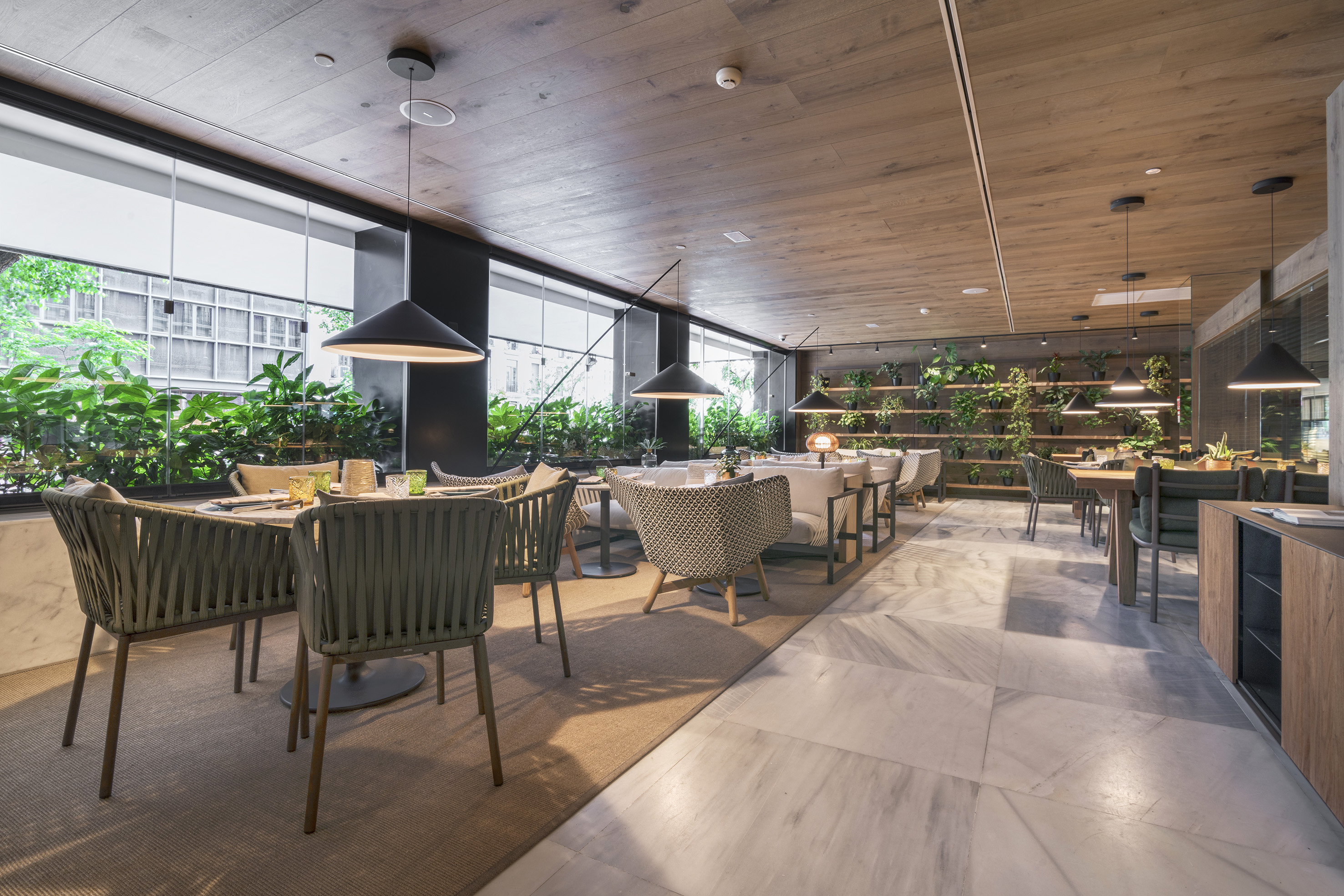 Modern restaurant interior with biophilic design, wood ceiling, marble floor, natural light.