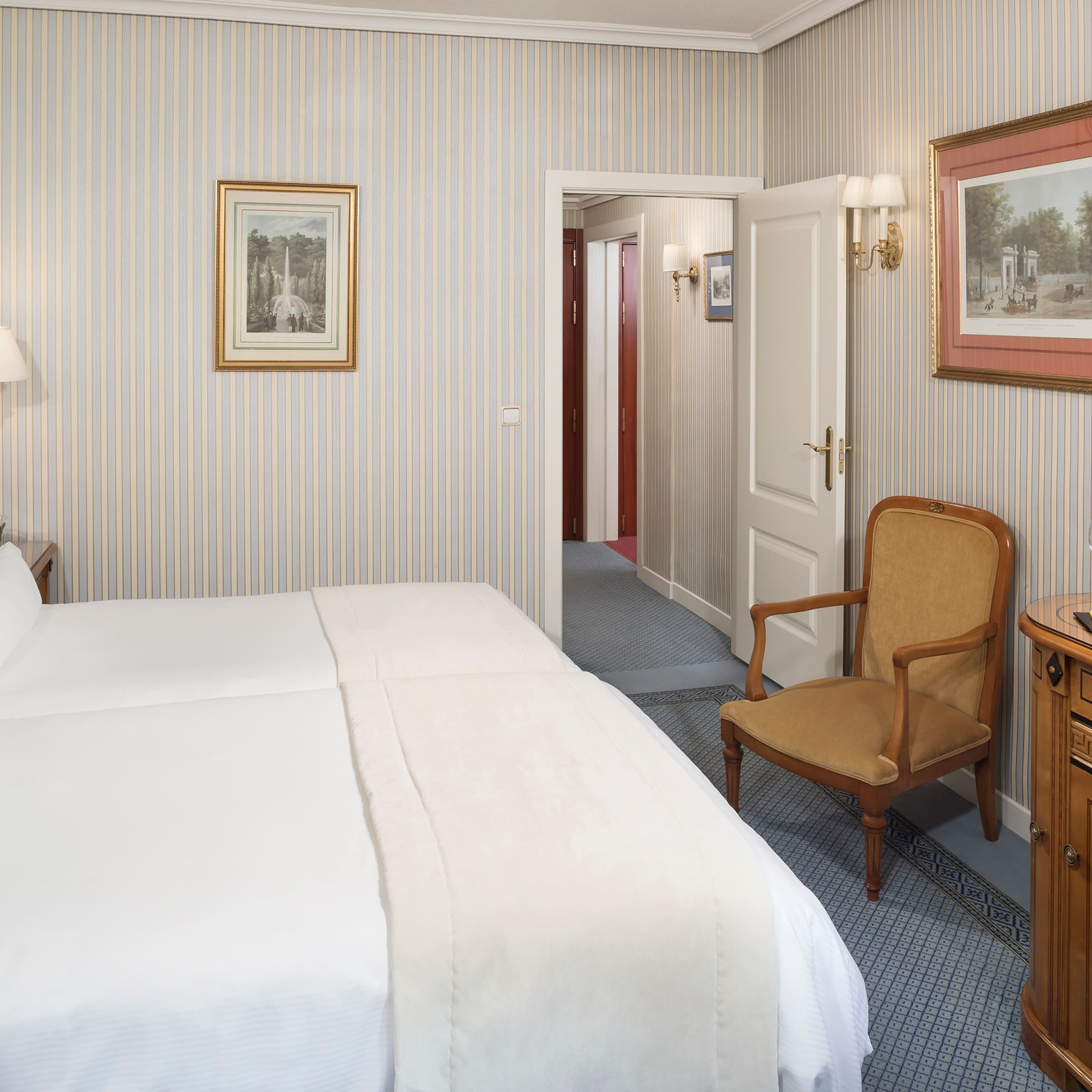 a bedroom with a bed and a chair