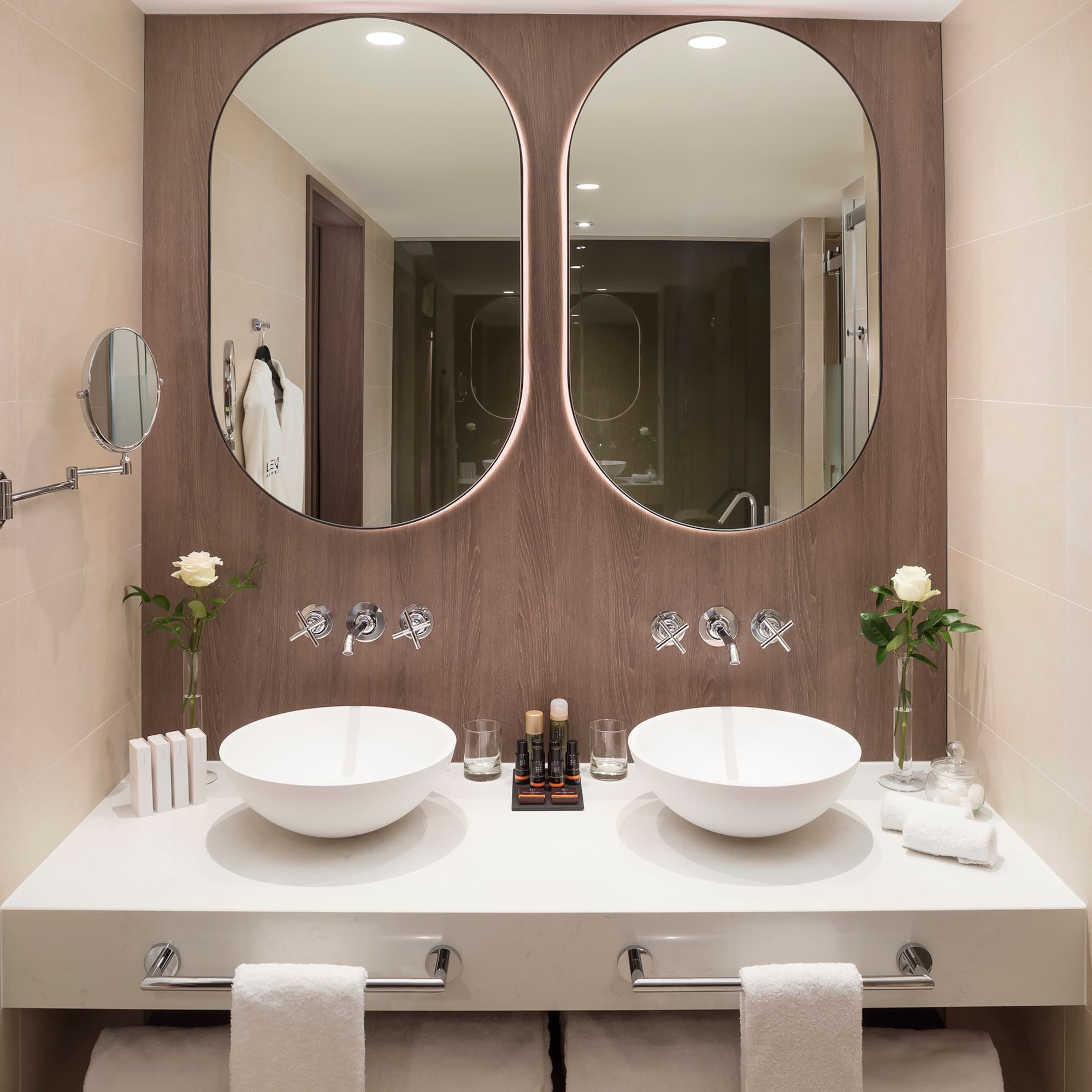 a bathroom with two sinks and mirrors