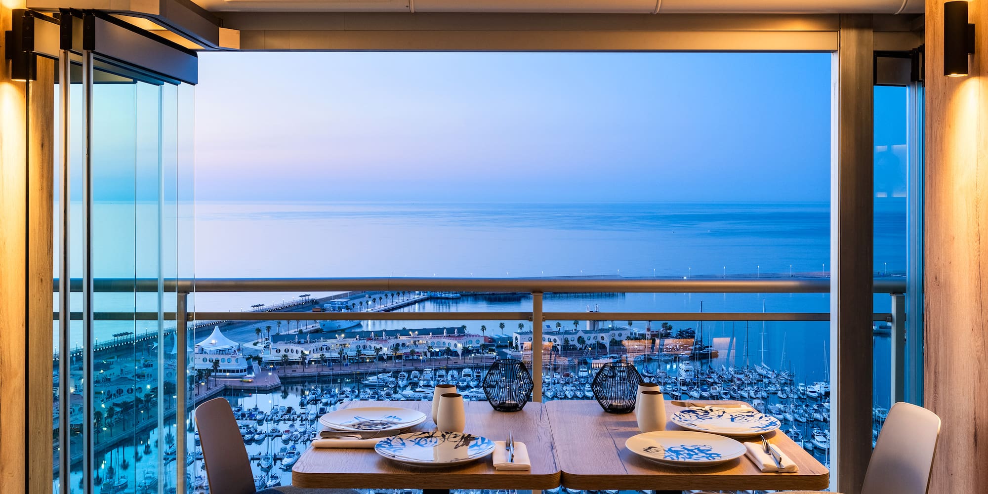 a table with plates and plates on it overlooking a body of water