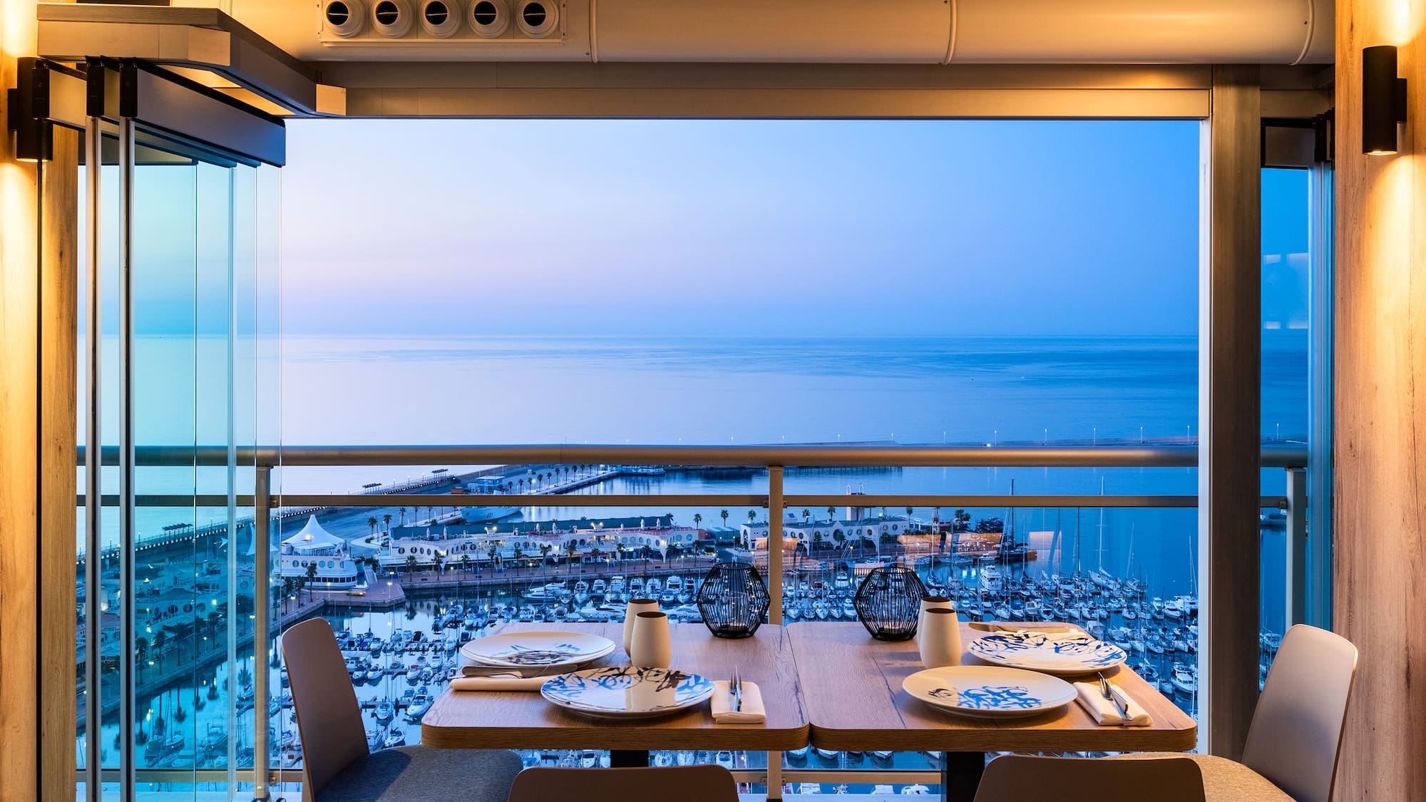 a table with plates and plates on it overlooking a body of water