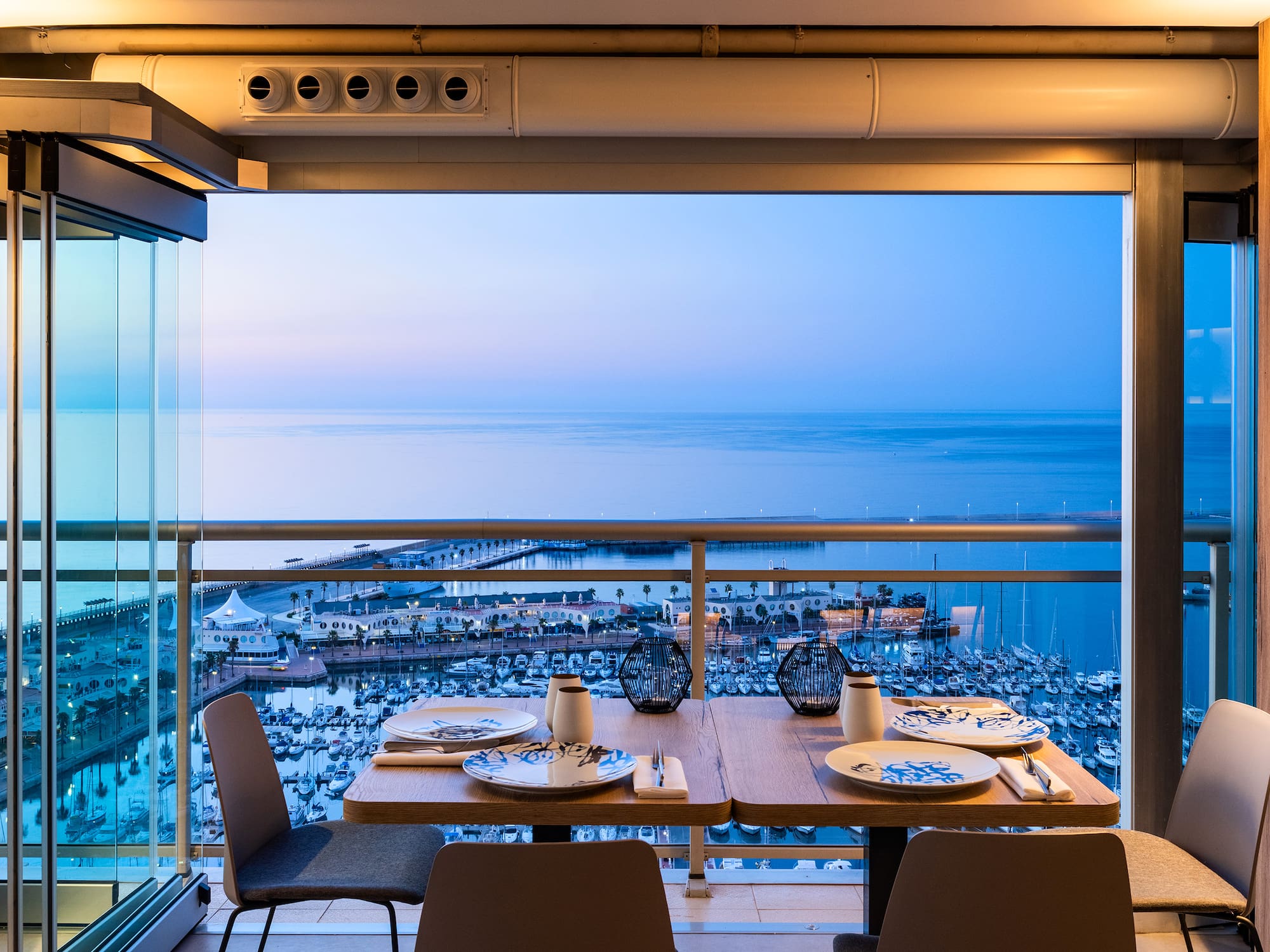 a table with plates and plates on it overlooking a body of water