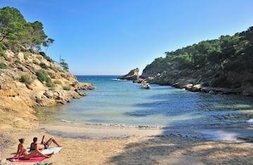 a couple of people sitting on a beach