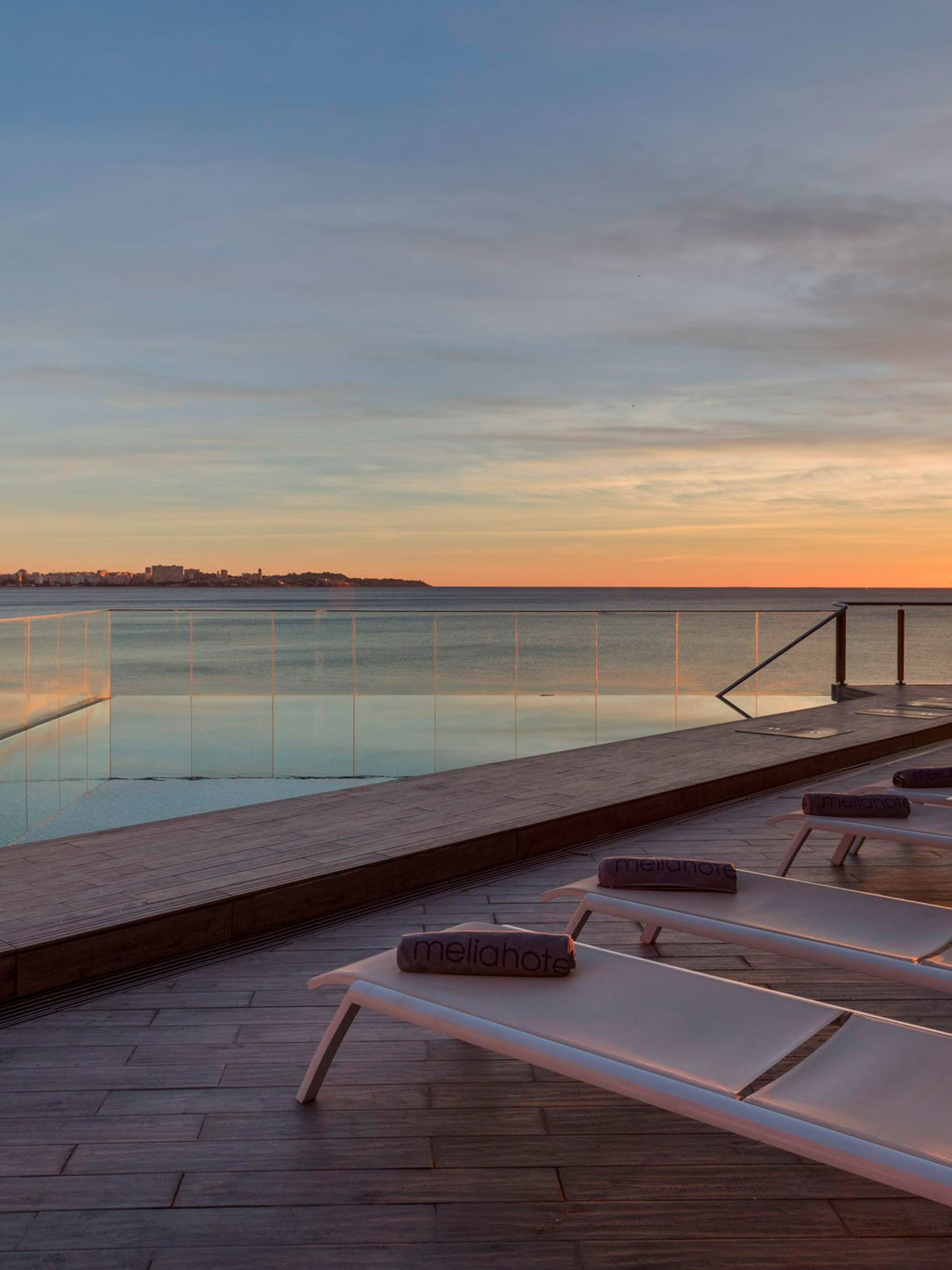 a pool with a body of water and chairs