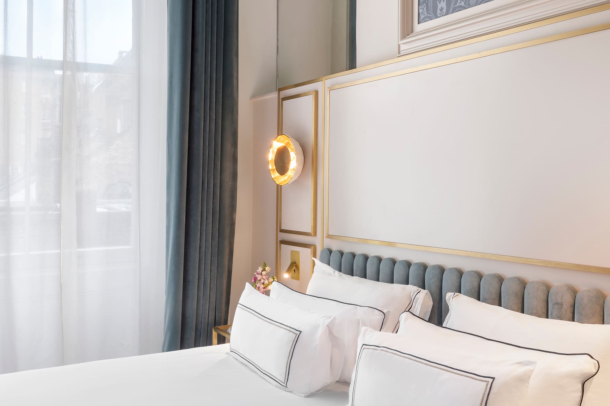 a bed with white sheets and pillows