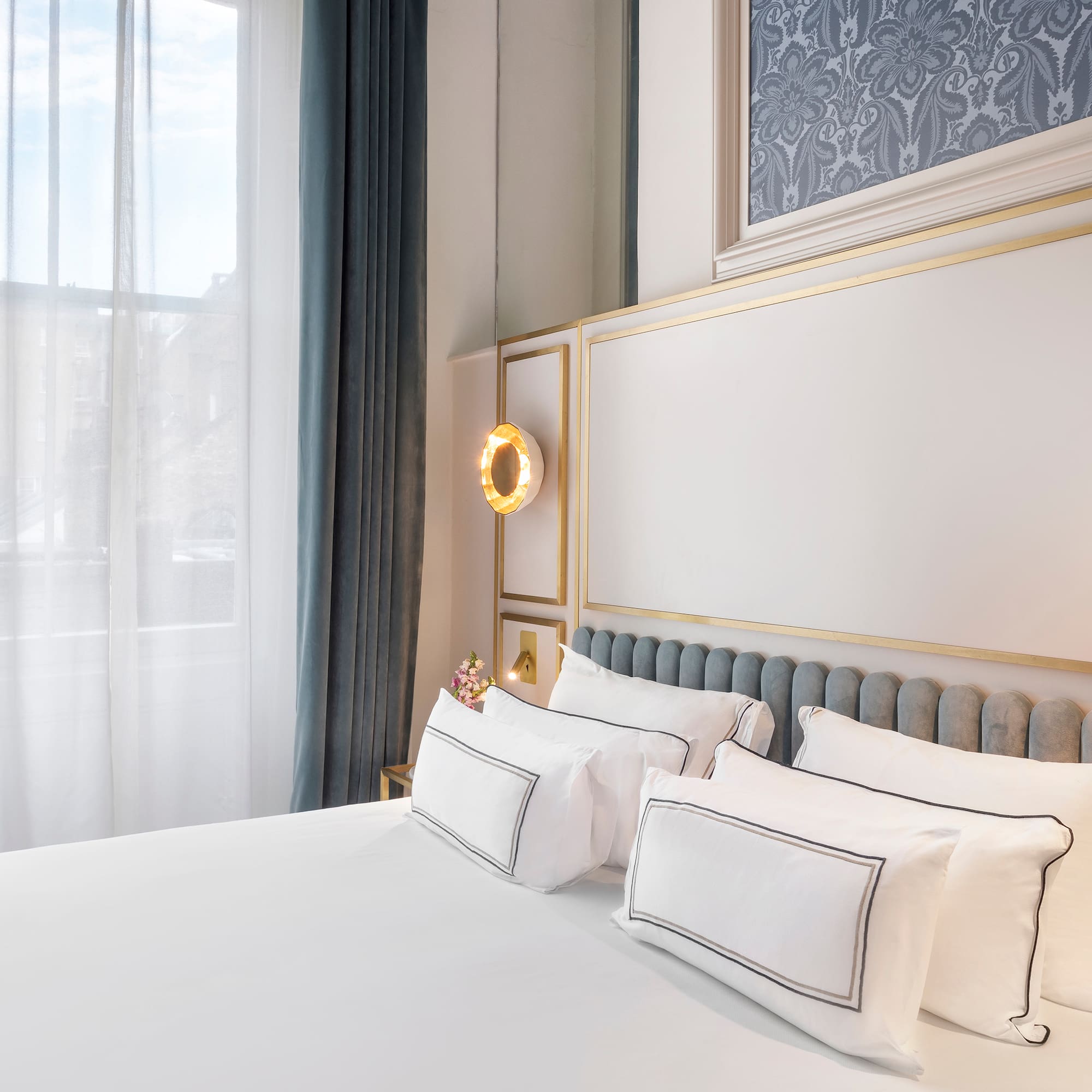 a bed with white sheets and pillows