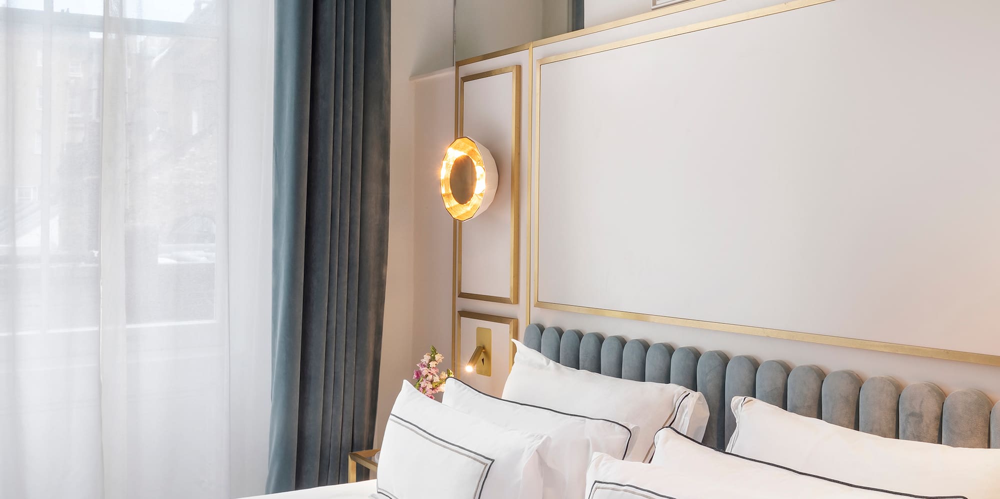 a bed with white sheets and pillows